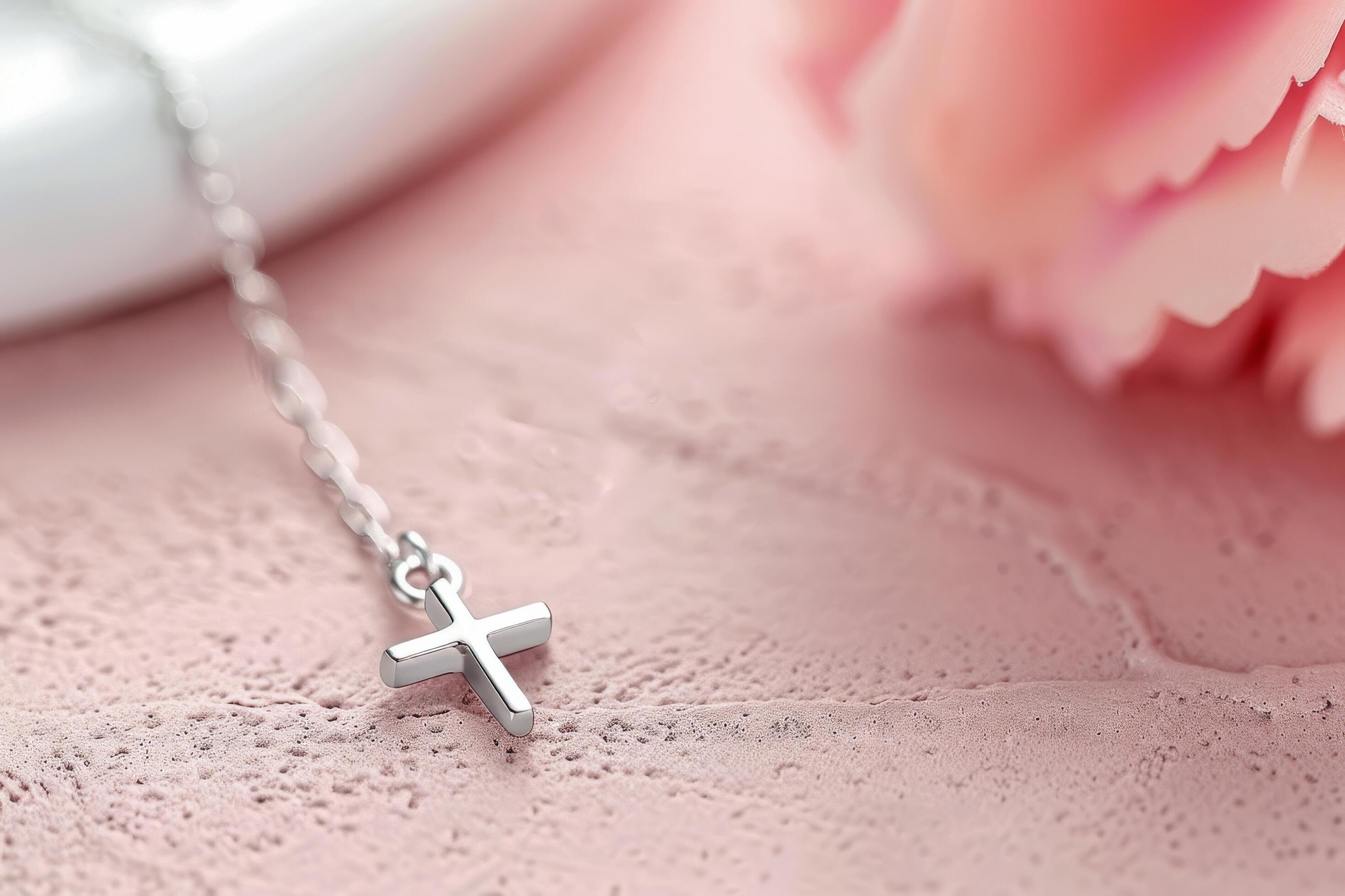 Silver Cross Necklace on Pink Background Stock Free