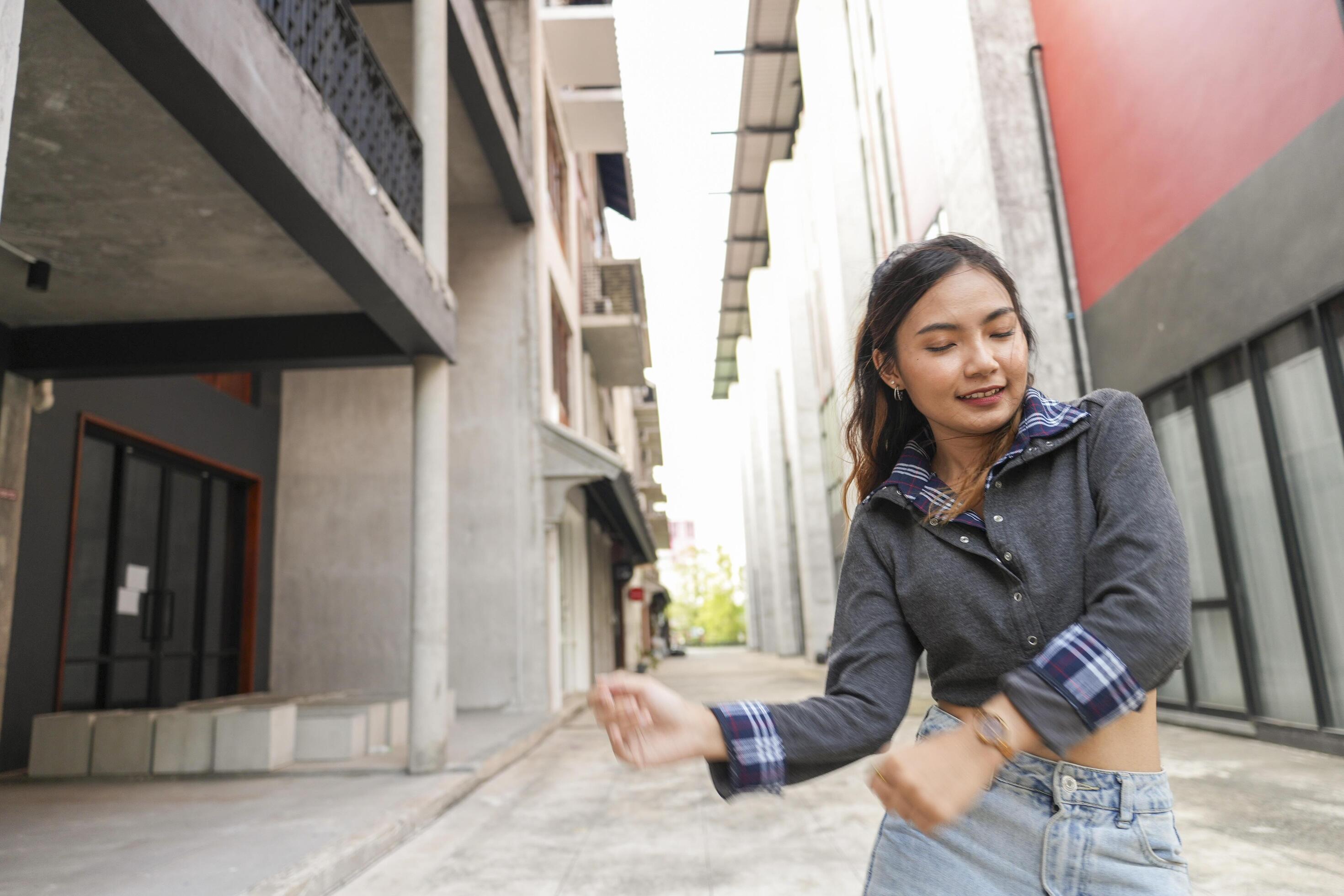 Asian women do freestyle hip hop and breakdancing in a public space in the middle of the city. With a cheerful and happy attitude Stock Free