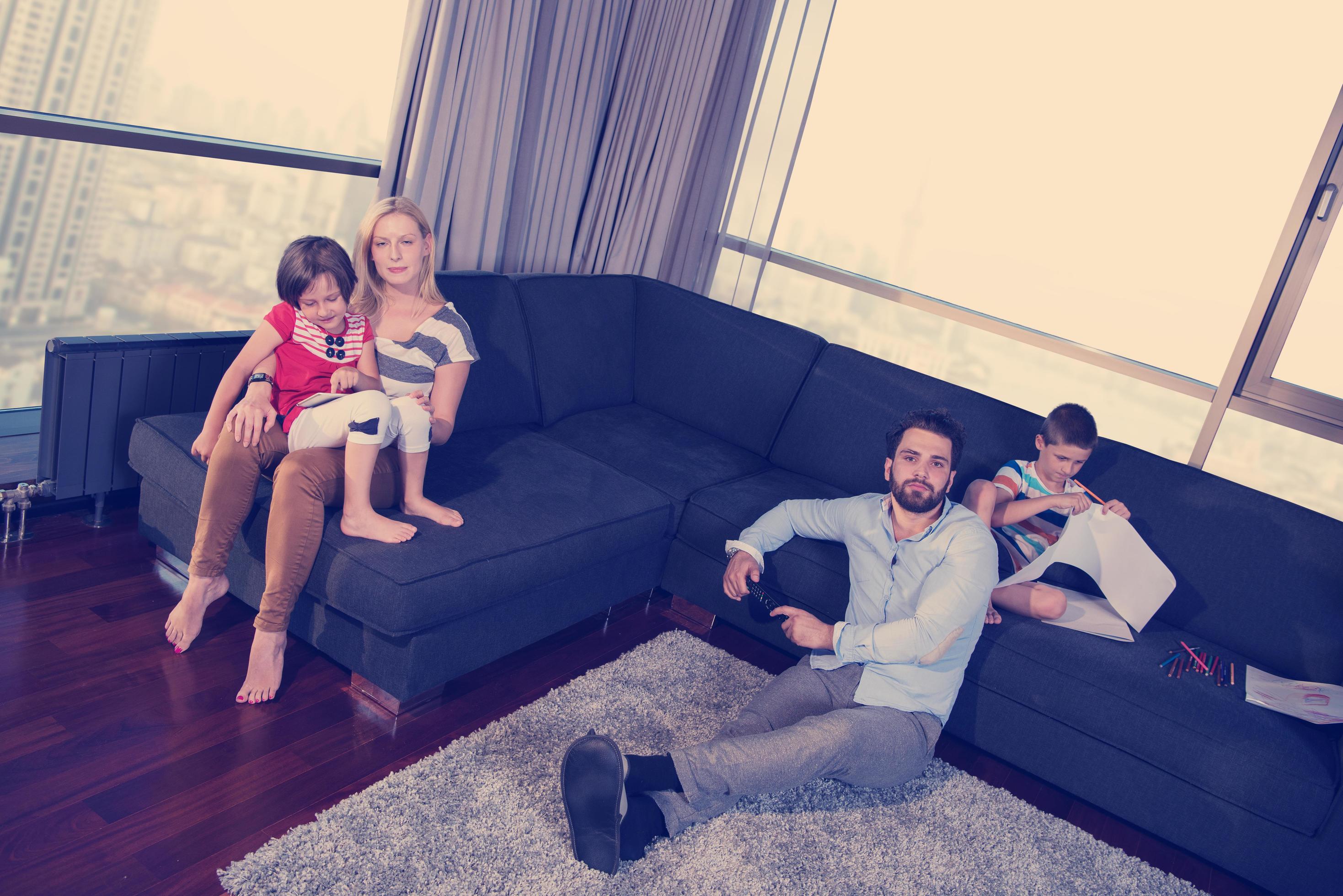 Happy Young Family Playing Together on sofa Stock Free