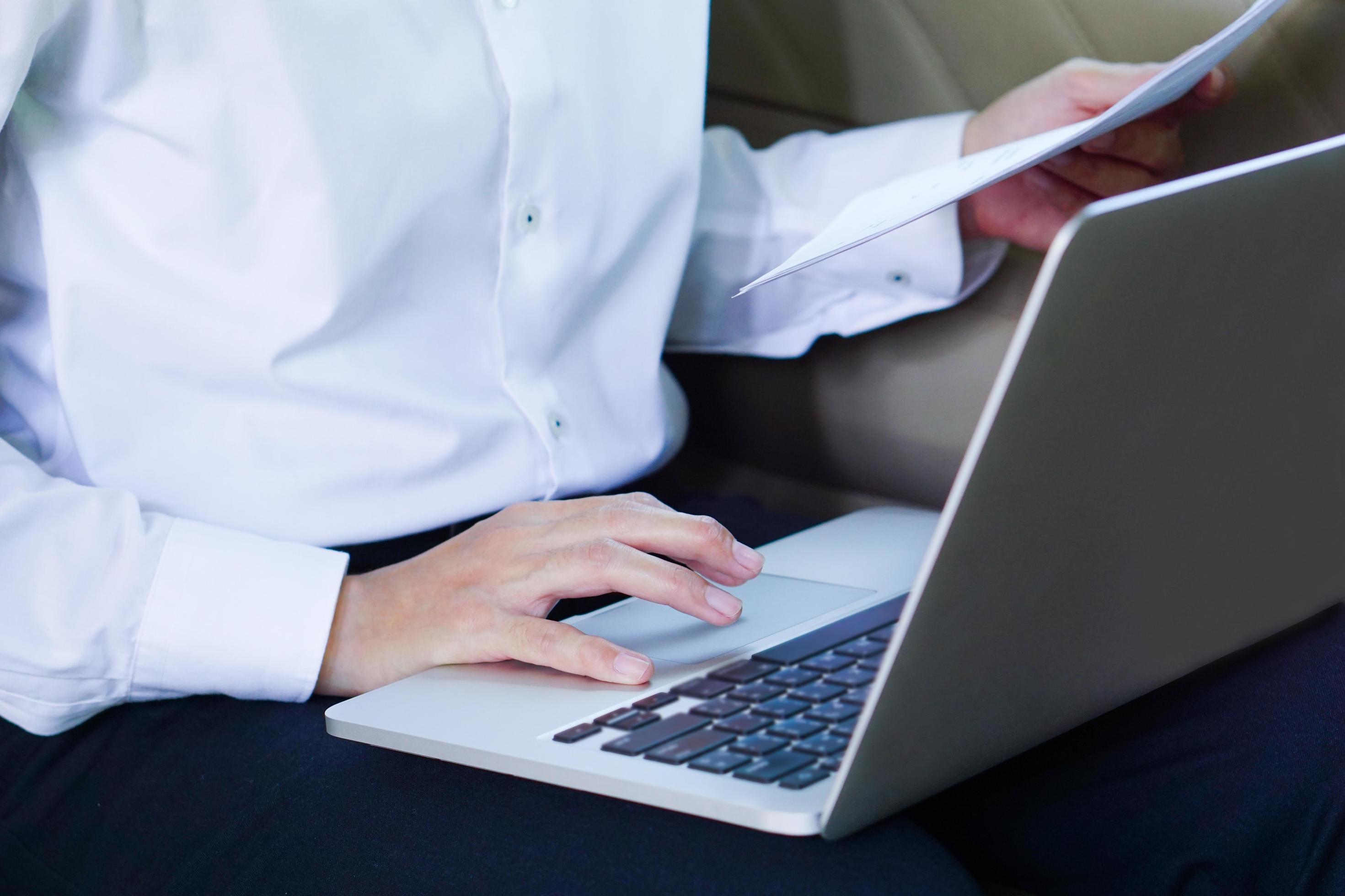 Businessman working on laptop while sitting on driver seat in car. Lifestyle concept. Stock Free