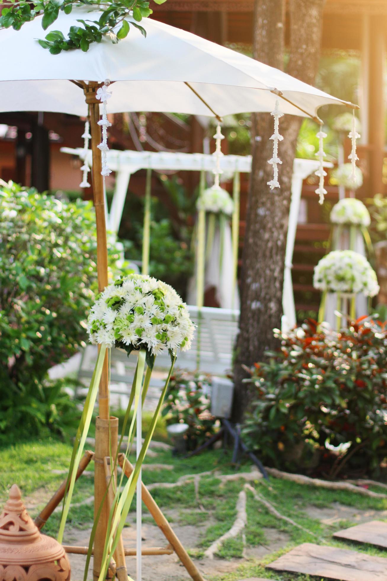 White birdcage decoration with roses and white flowers hanging decoration in garden for wedding ceremony Stock Free