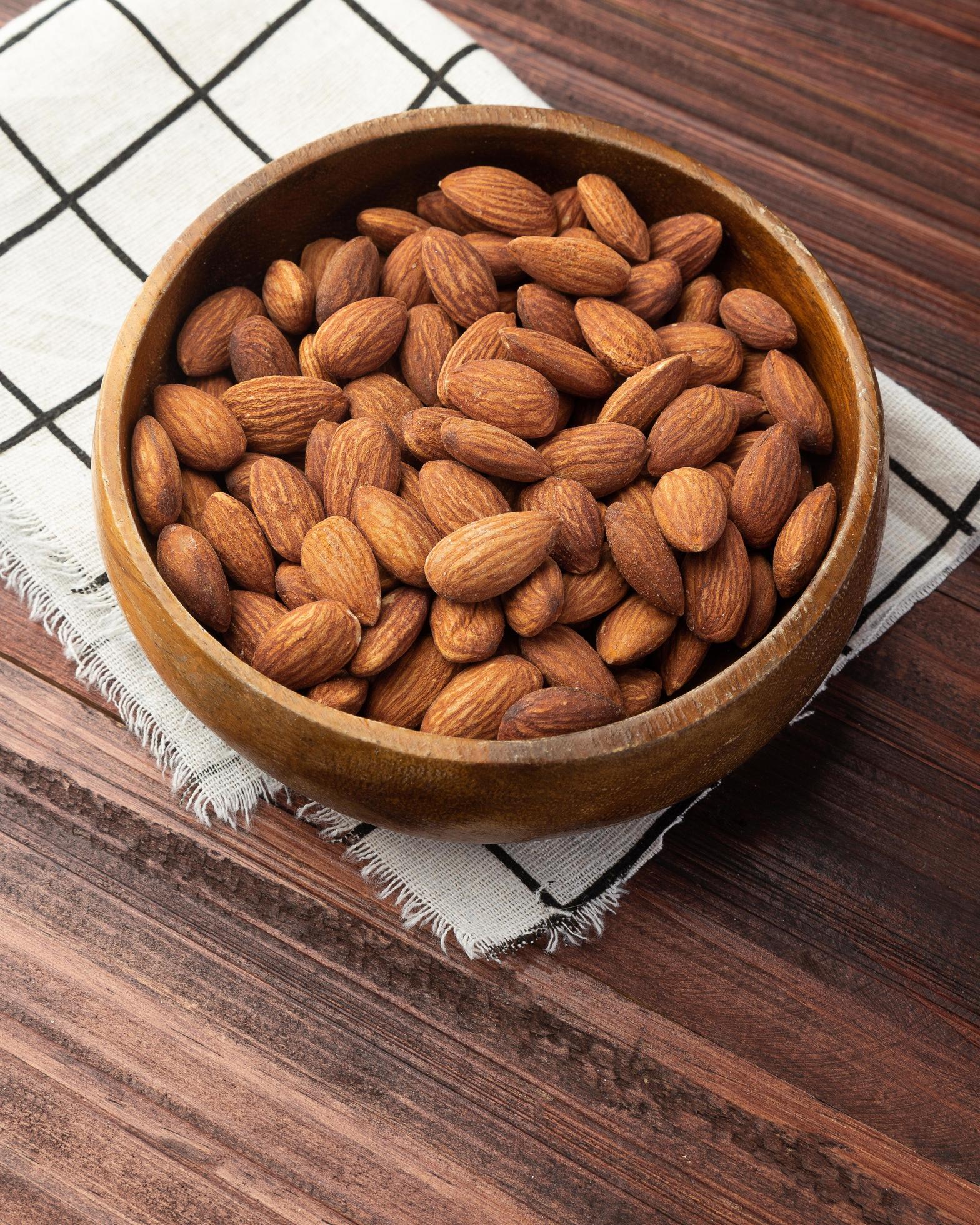 
									Almonds in wooden bowl on the table, Healthy snack, Vegetarian food Stock Free