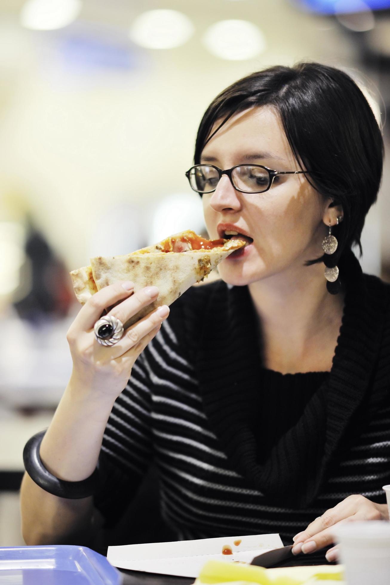 woman eat pizza food at restaurant Stock Free