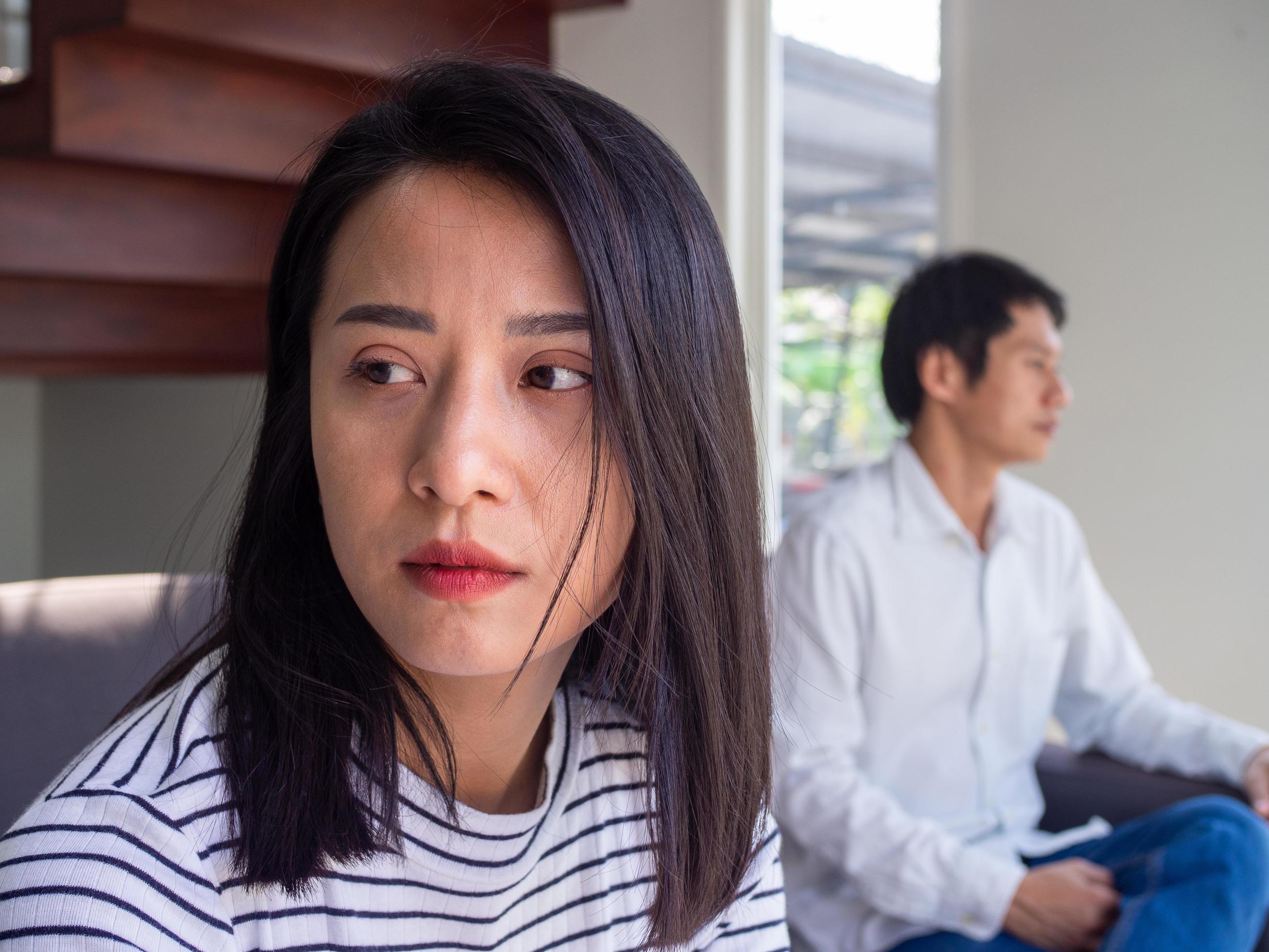 An Asian woman is unhappy and hurt after an argument with her husband due to their distrust. Concepts of family problems and love problems Stock Free