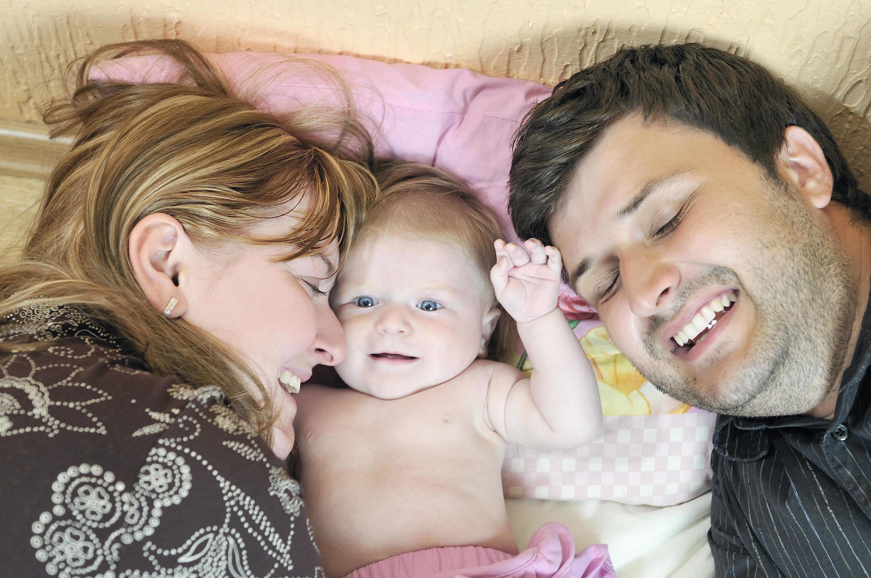 portrait of young family with cute little babby Stock Free