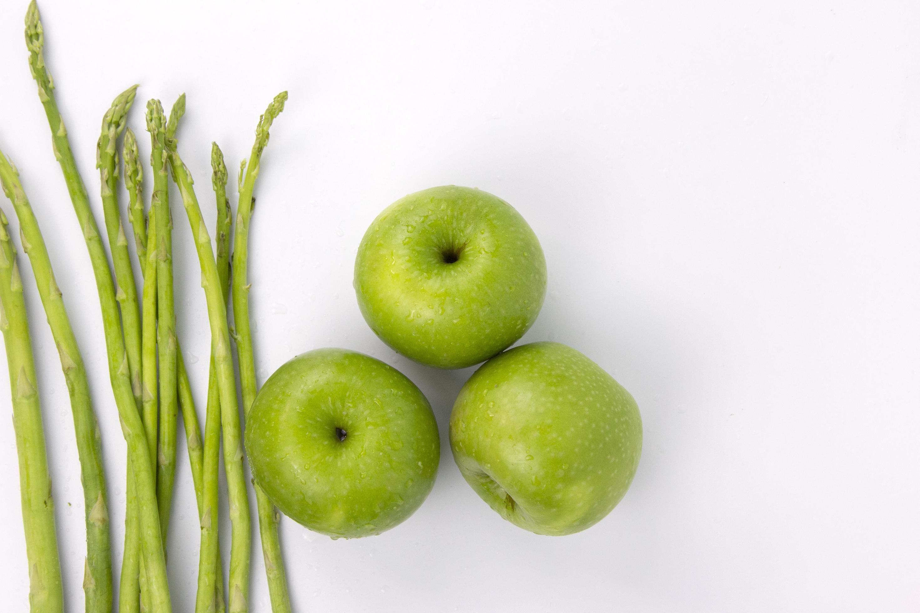 Green Asparagus and fresh apples isolated on white background, healthy food concepts Stock Free