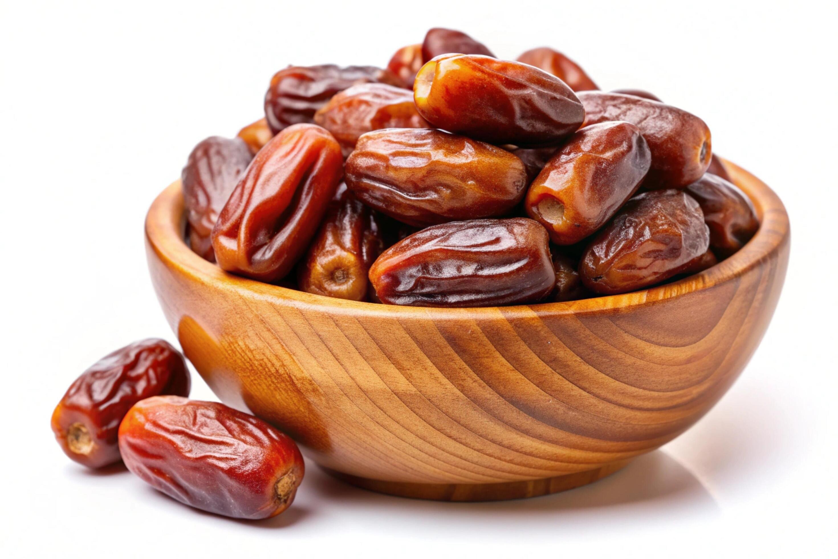 Dates in wood bowl isolated on white background Stock Free