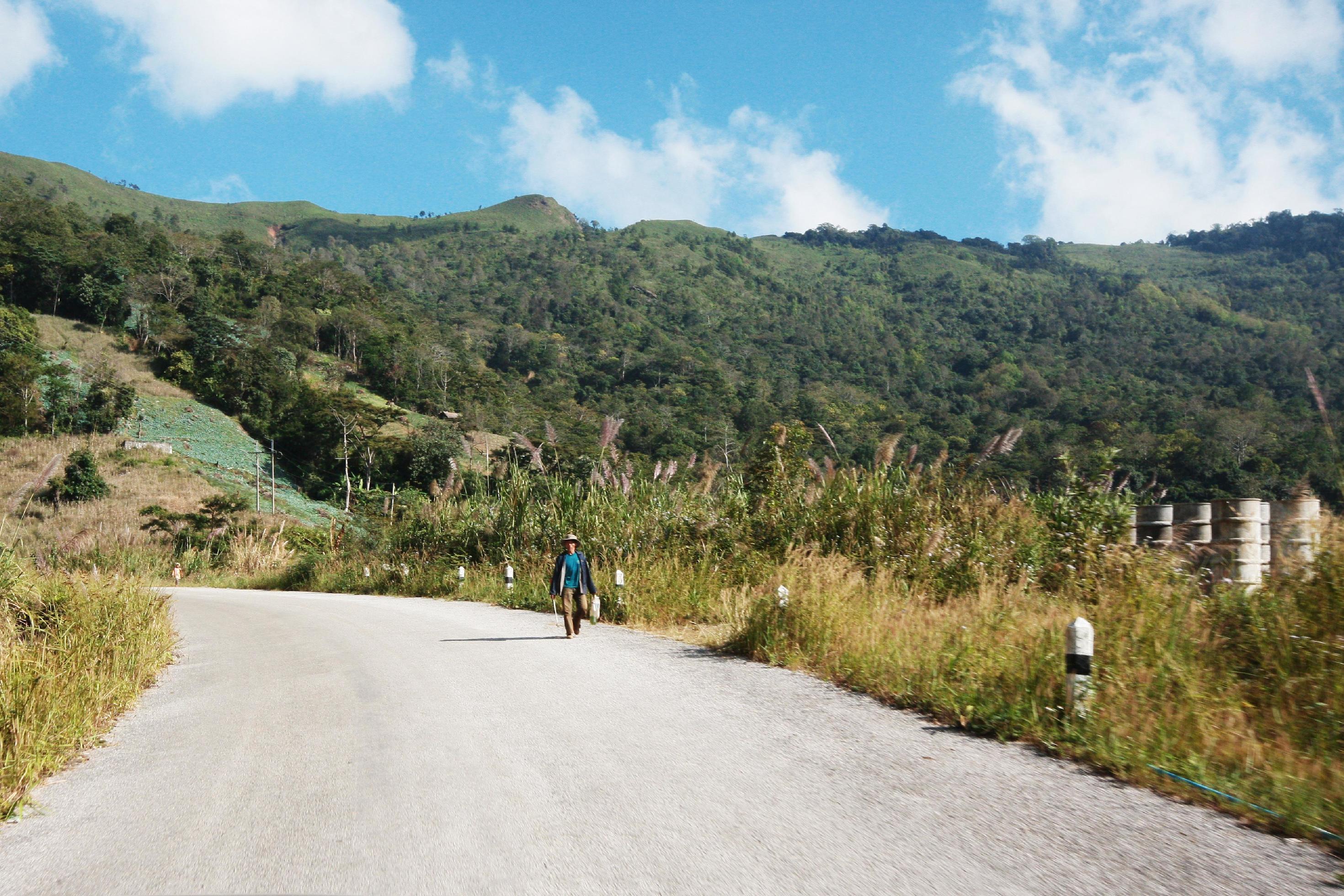 Life of hill tribe farmers walking in country road on the mountain in Thailand Stock Free