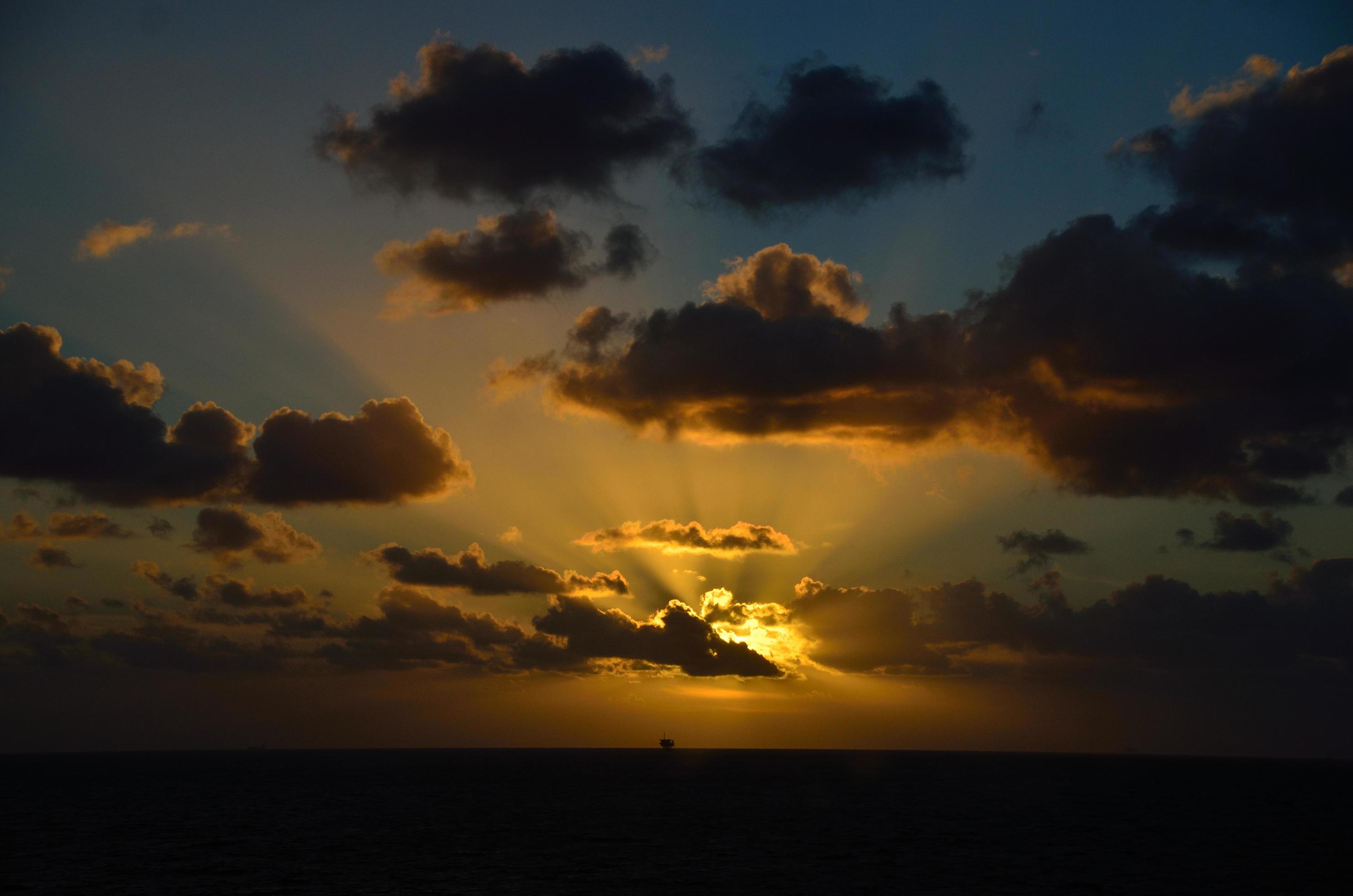 glowing sunset on sea with ship Stock Free