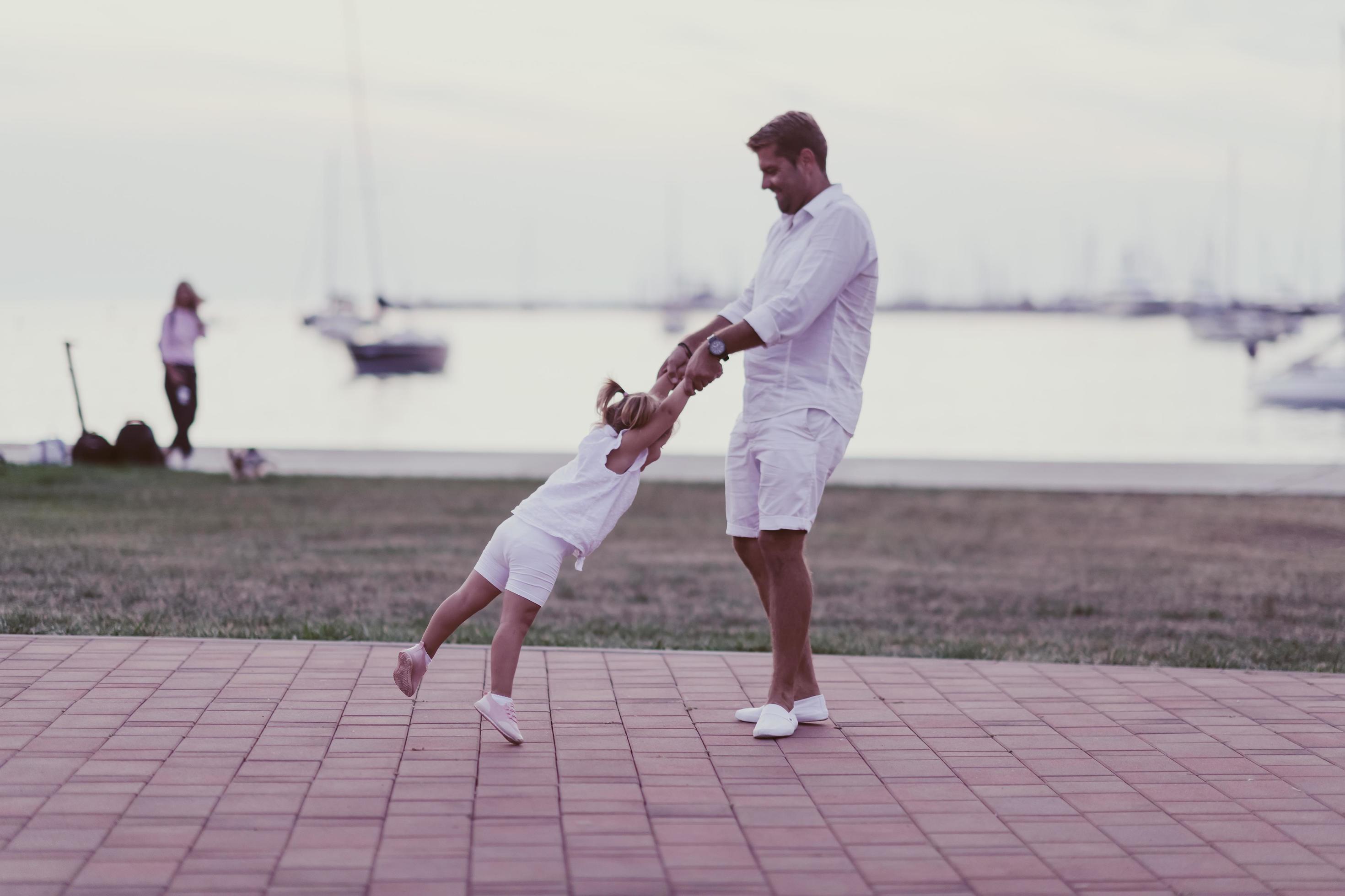 An elderly man in casual clothes with his daughter spends time together in the park on vacation. Family time. Selective focus Stock Free