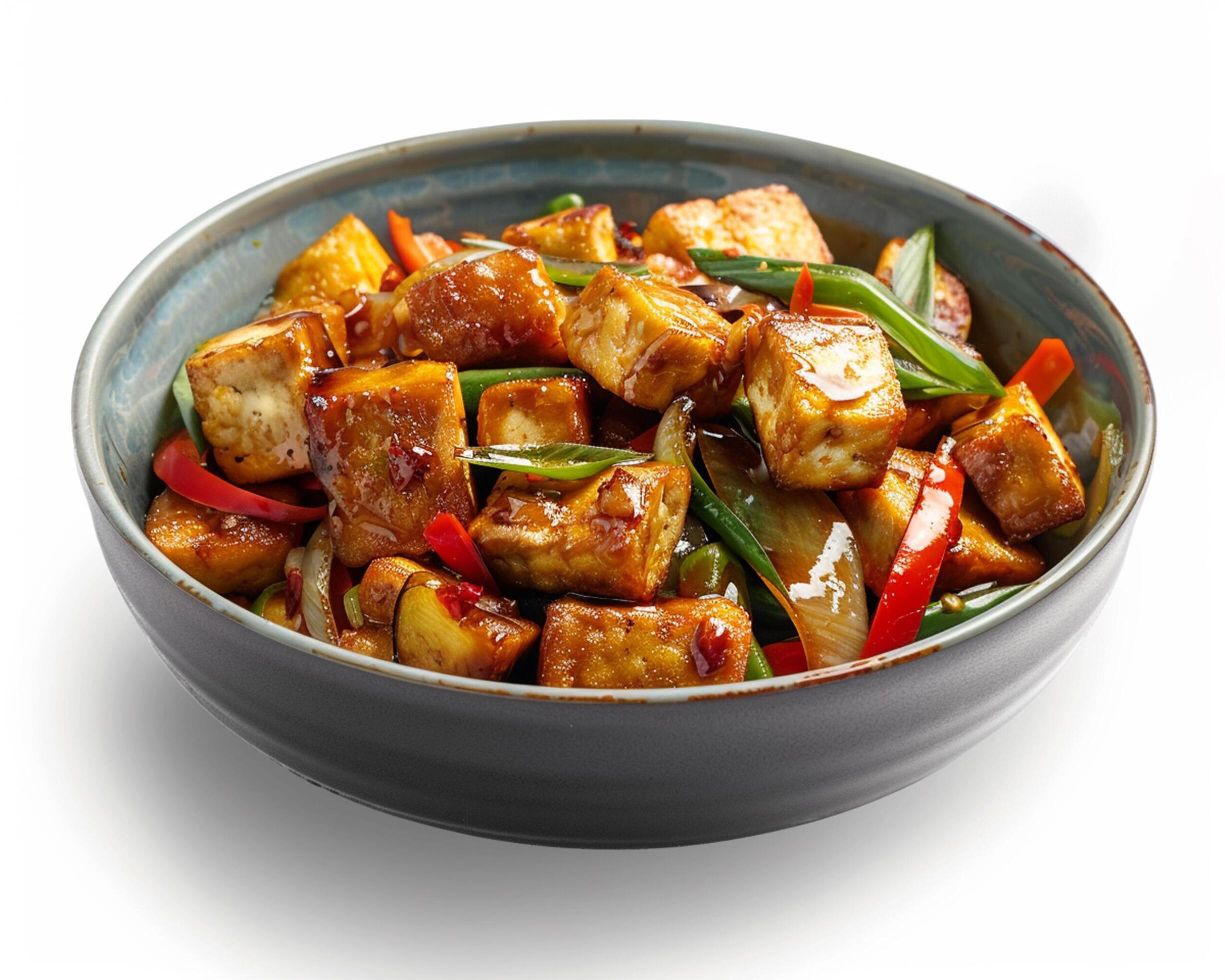 a bowl of tofu with peppers and onions Stock Free