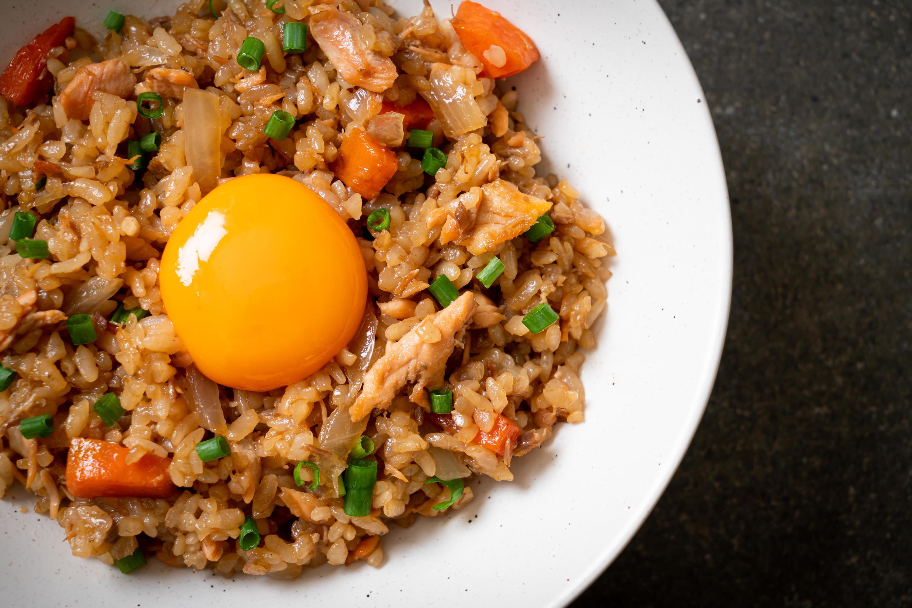 Salmon fried rice with pickled egg on top – Asian food style Stock Free