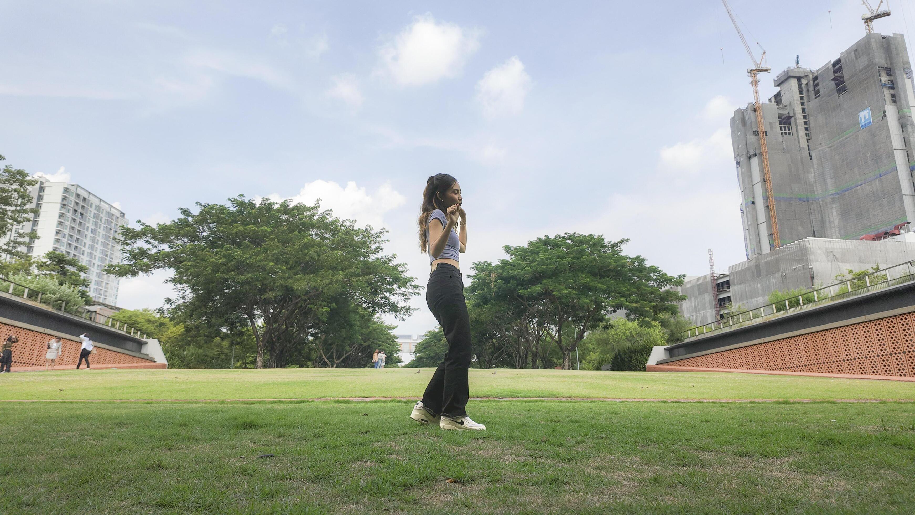 Asian women do freestyle hip hop and breakdancing in a public space in the middle of the city. With a cheerful and happy attitude Stock Free