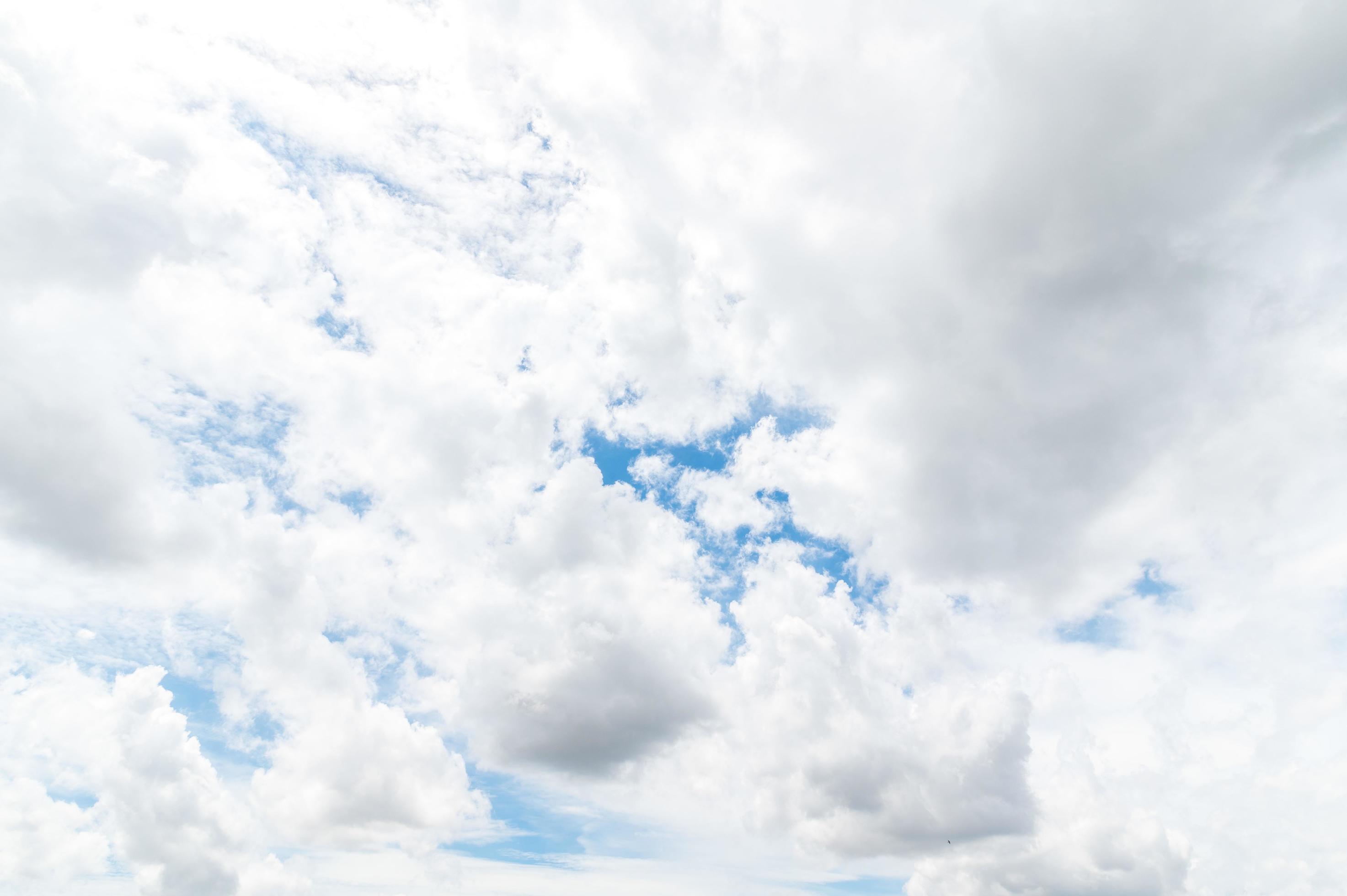 Nature background from white clouds in sunny day. Beautiful white fluffy clouds in blue sky. Stock Free