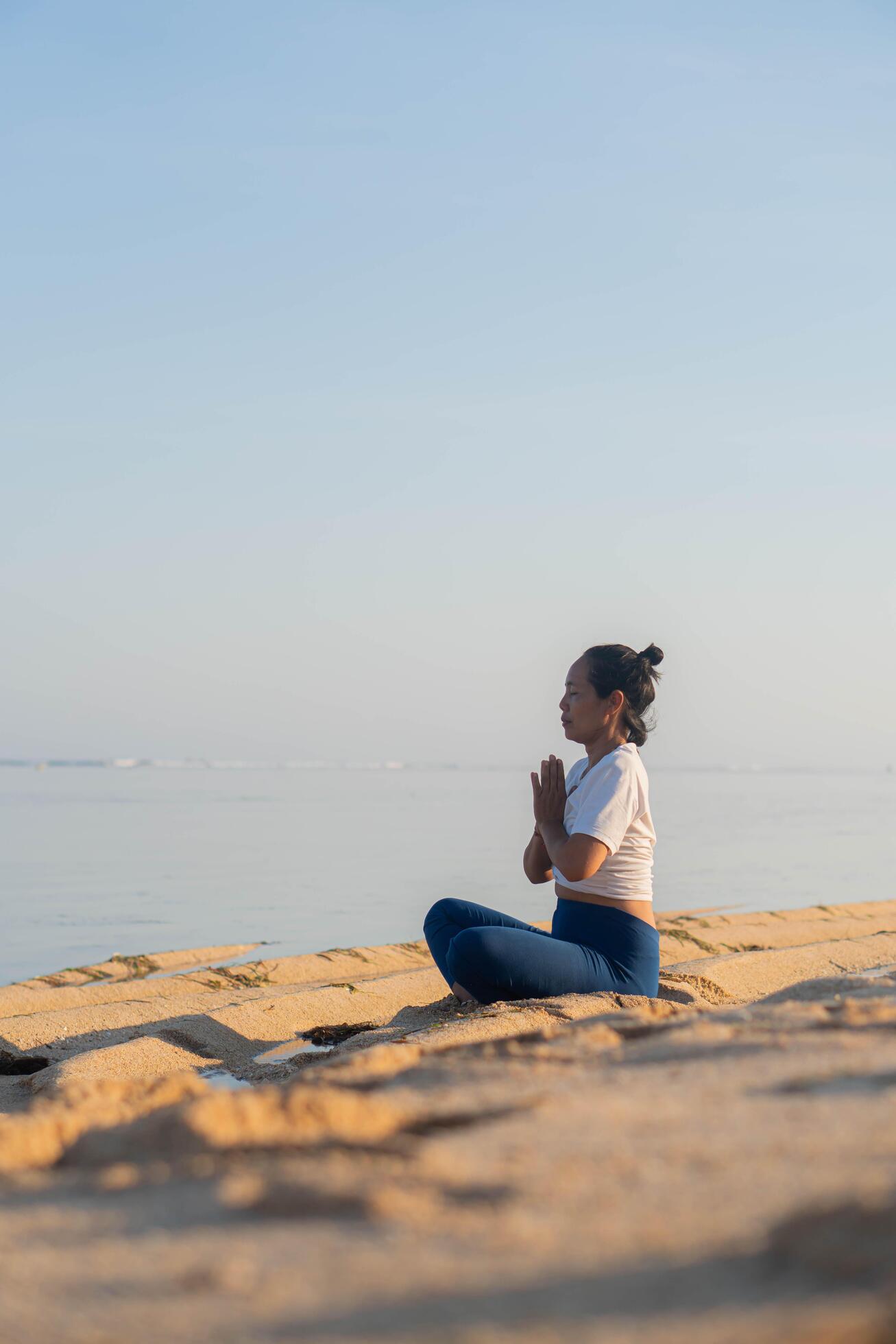 healthy woman with beautiful body doing yoga at sunrise on the beach, yoga poses Stock Free