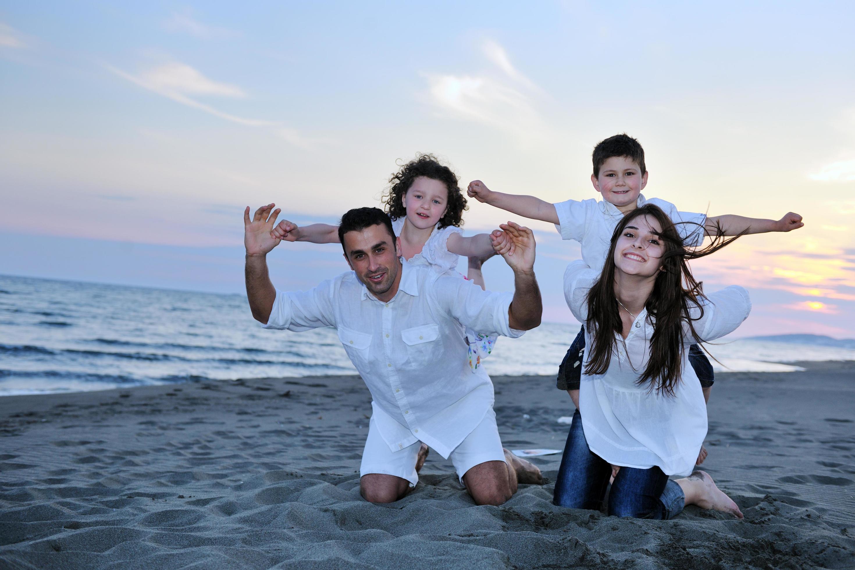 happy young family have fun on beach Stock Free