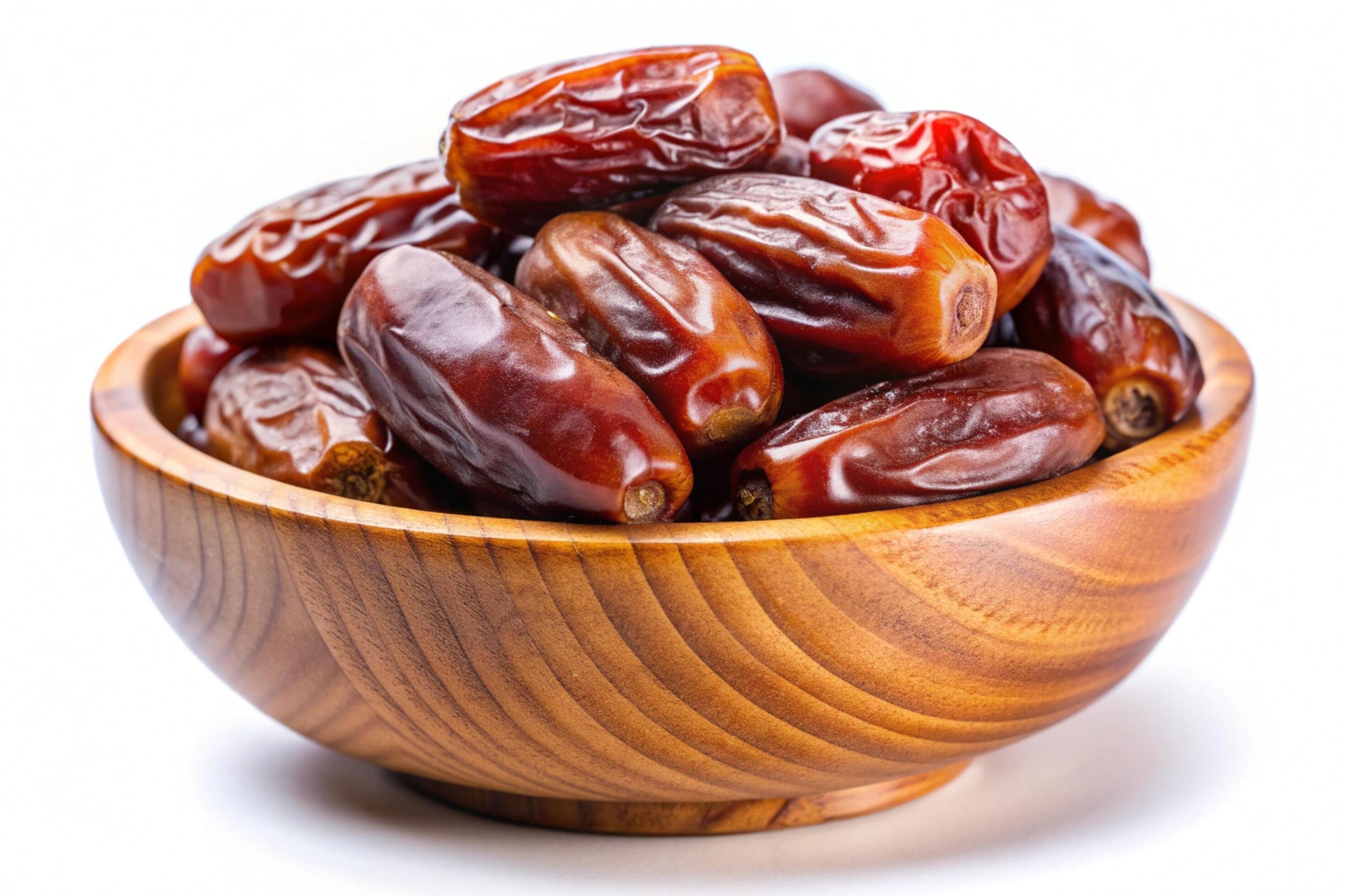 Dates in wood bowl isolated on white background Stock Free