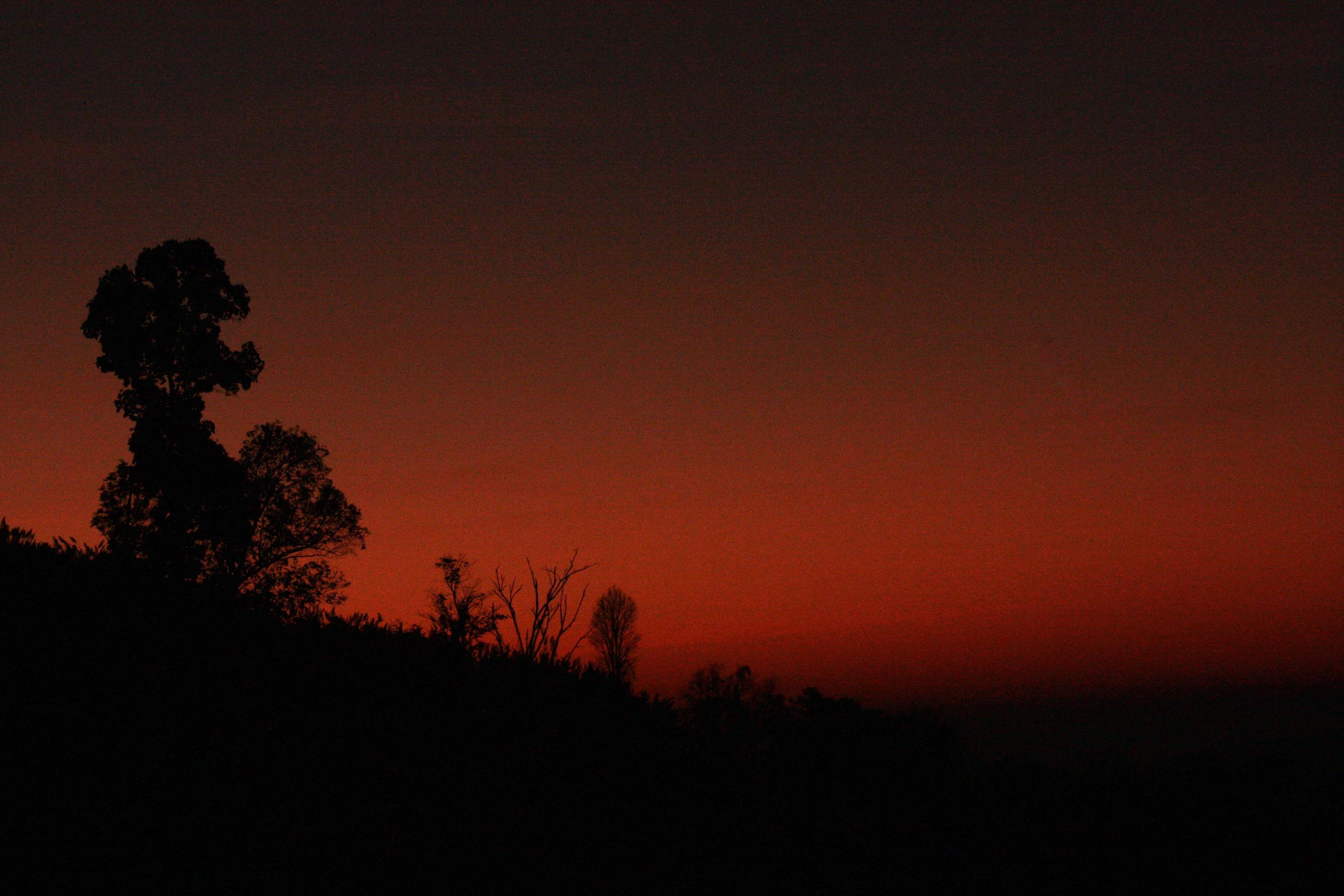 Beautiful silhouette of moments in natural sunrise and sunset on the mountain. Peace, loneliness and Haloween Concept. Stock Free