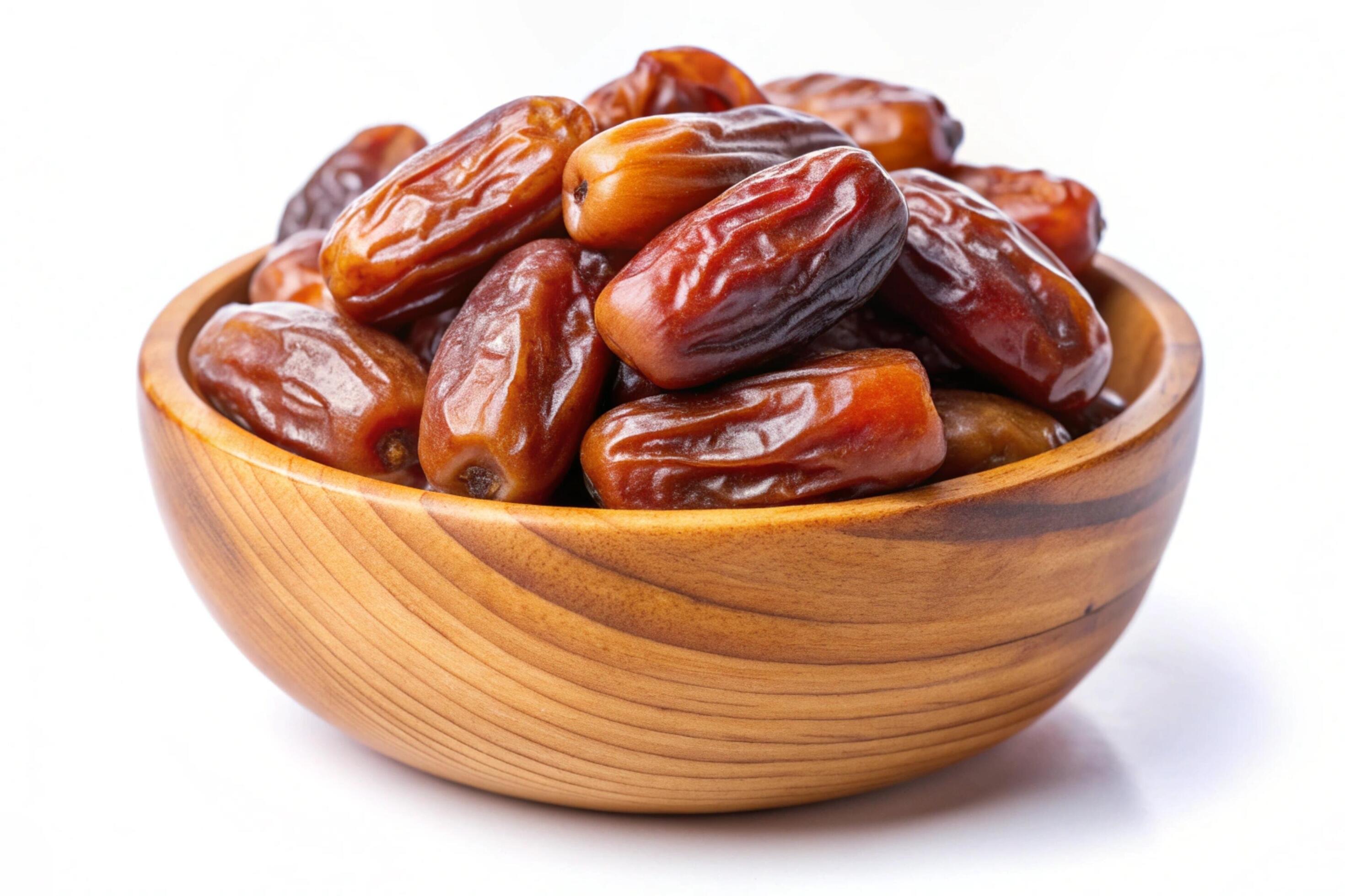 Dates in wood bowl isolated on white background Stock Free