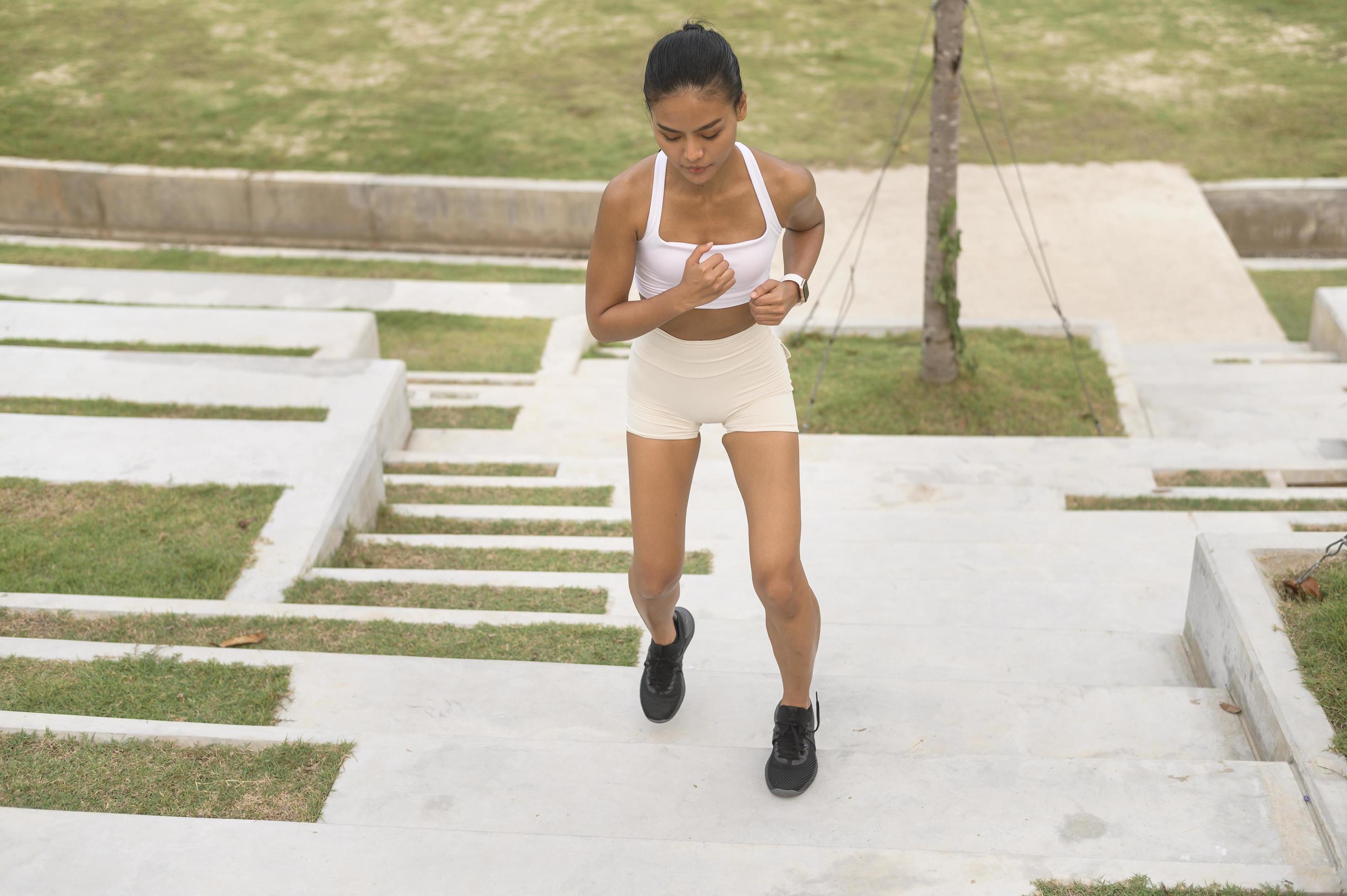 A young fitness woman in sportswear exercising in city park, Healthy and Lifestyles. Stock Free