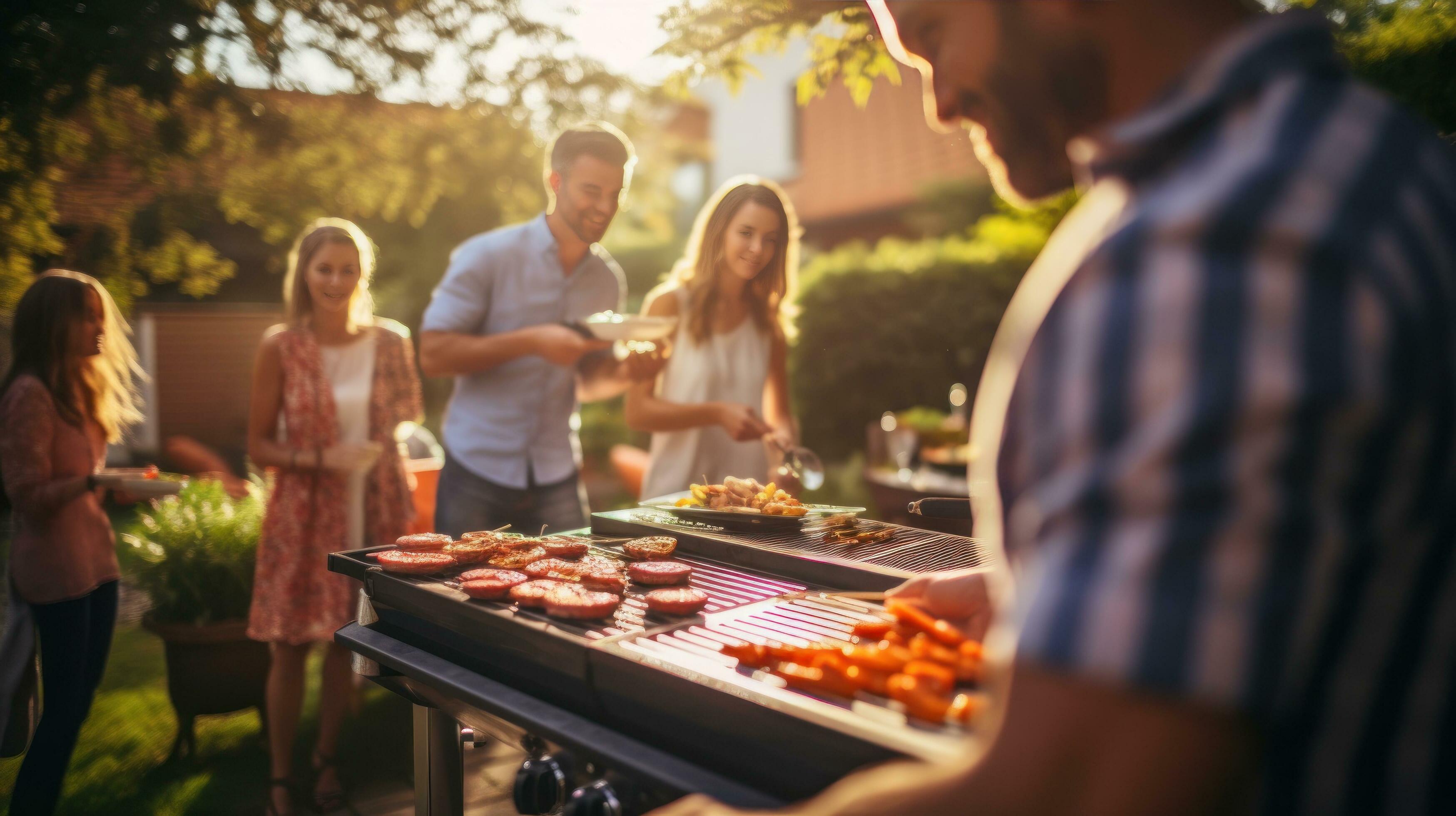 Young family is grilling at the barbecue Stock Free