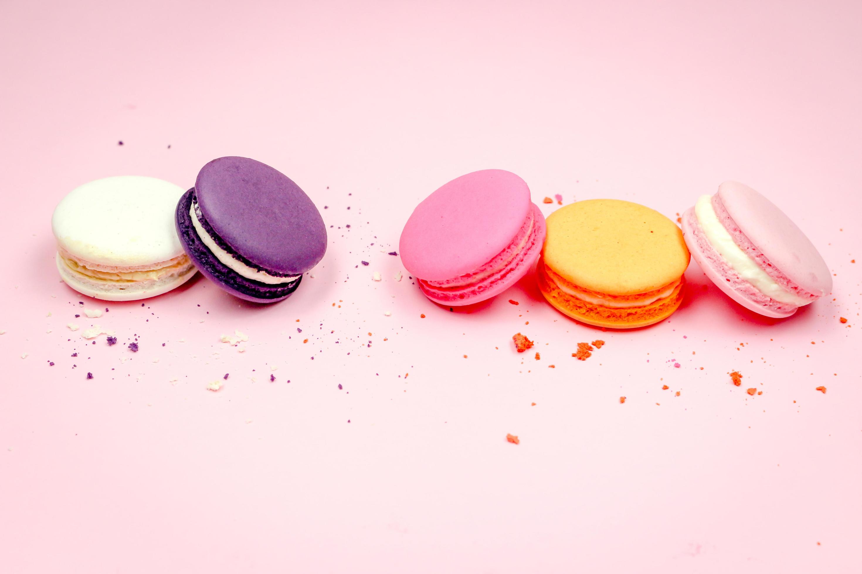 Colorful french macarons macaroons cake, delicious sweet dessert on a pink background with copyspace, food background concept. Stock Free