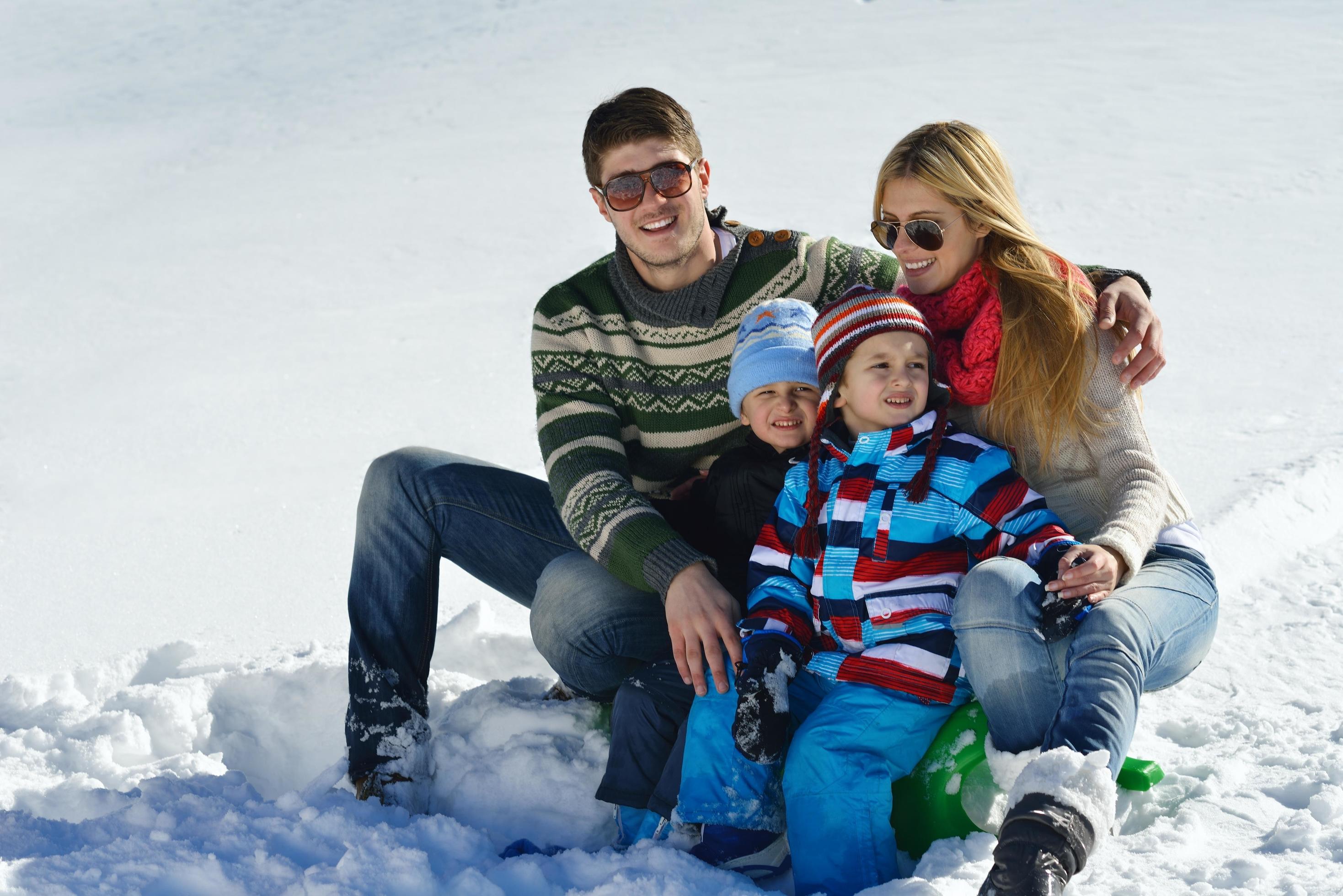 family having fun on fresh snow at winter Stock Free