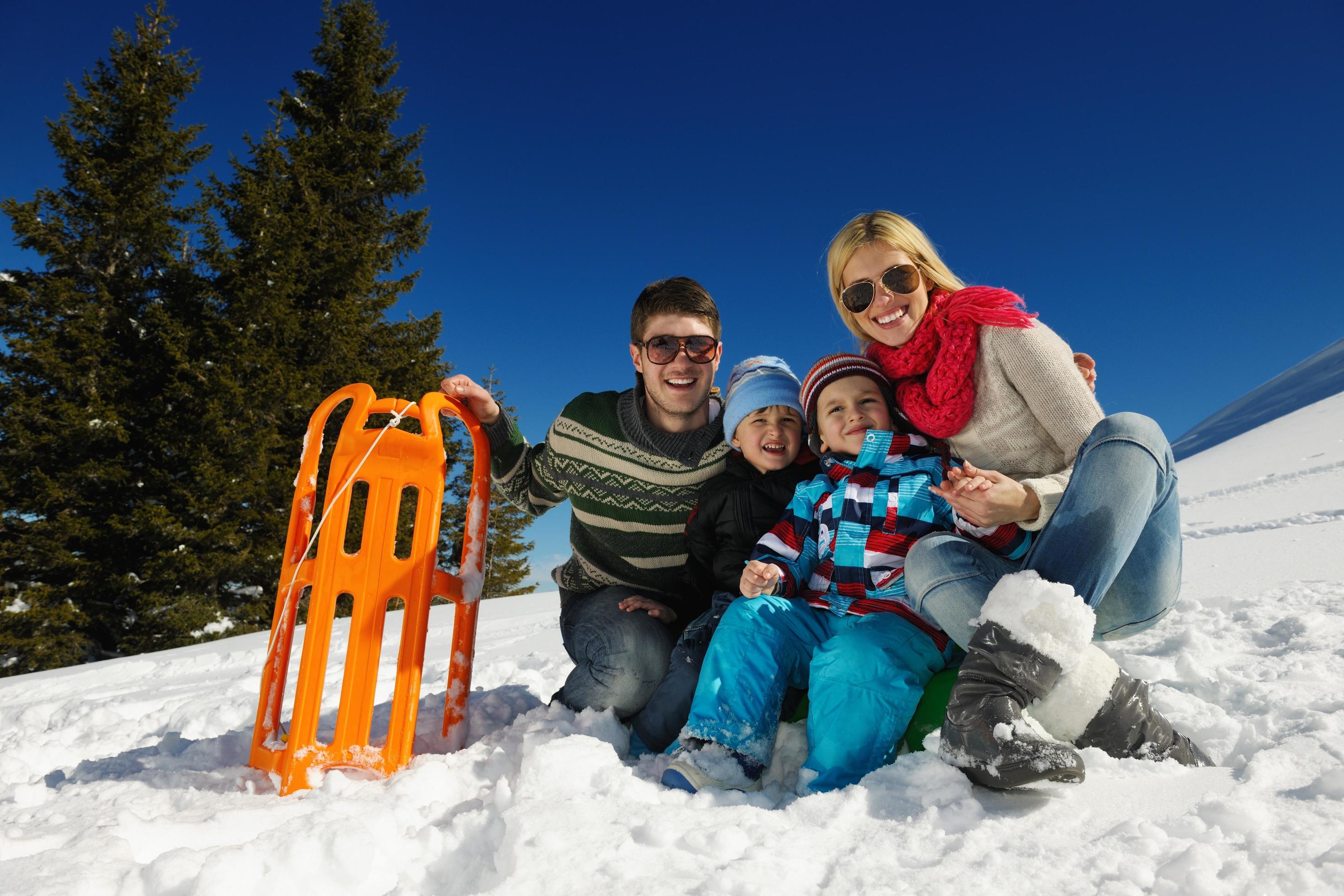 family having fun on fresh snow at winter Stock Free