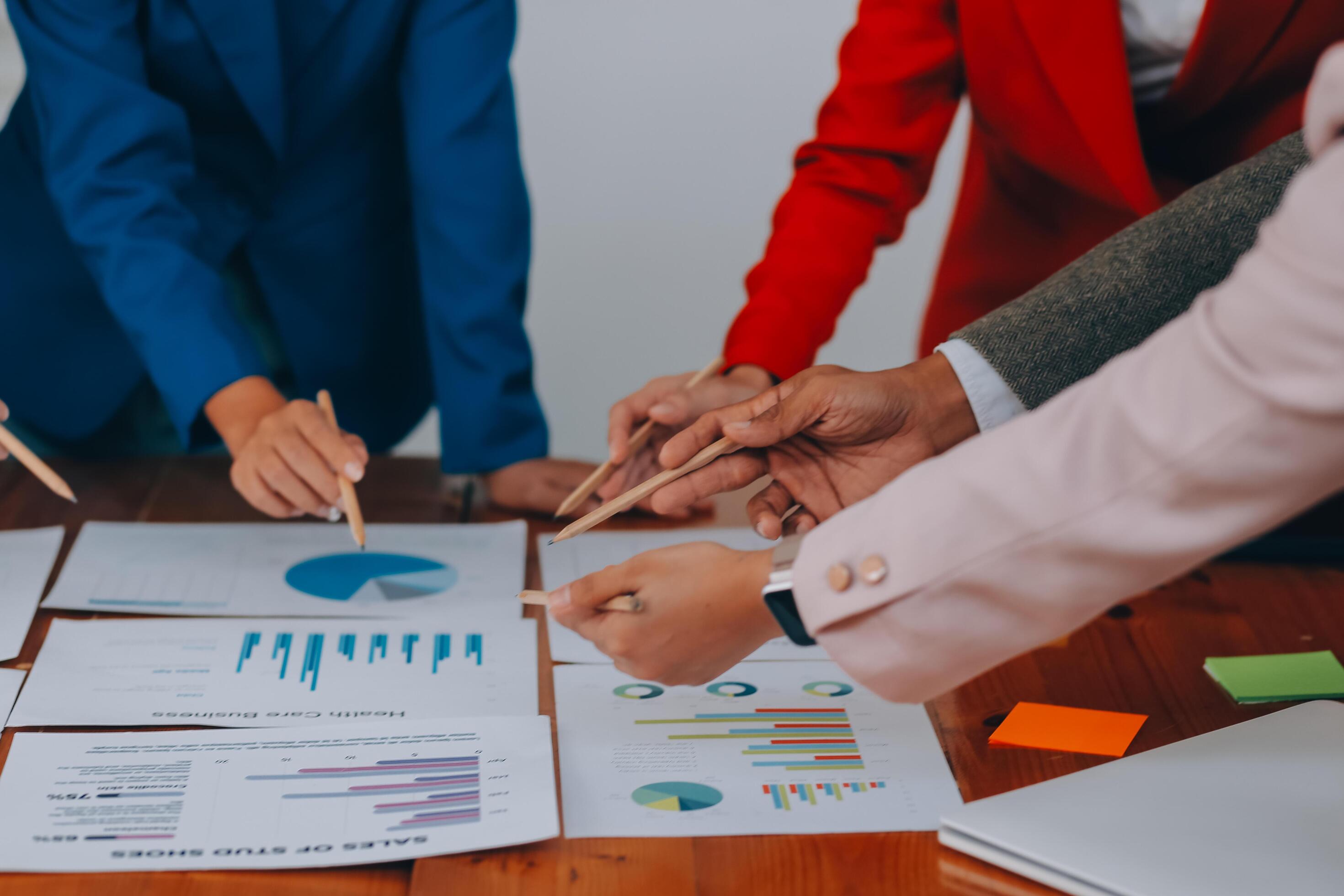 Business professionals. Group of young confident business people analyzing data using computer while spending time in the office Stock Free