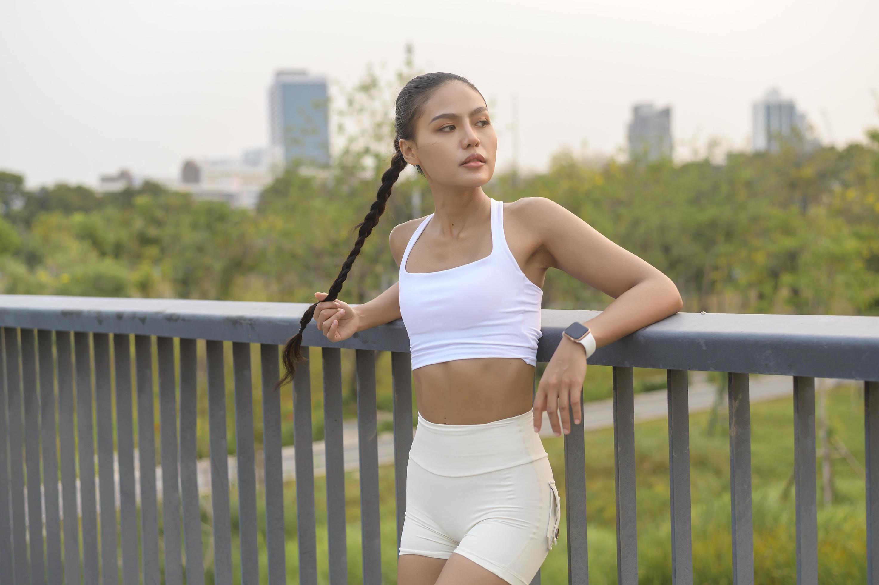 Portrait of young fitness woman in sportswear in city park, Healthy and Lifestyles. Stock Free