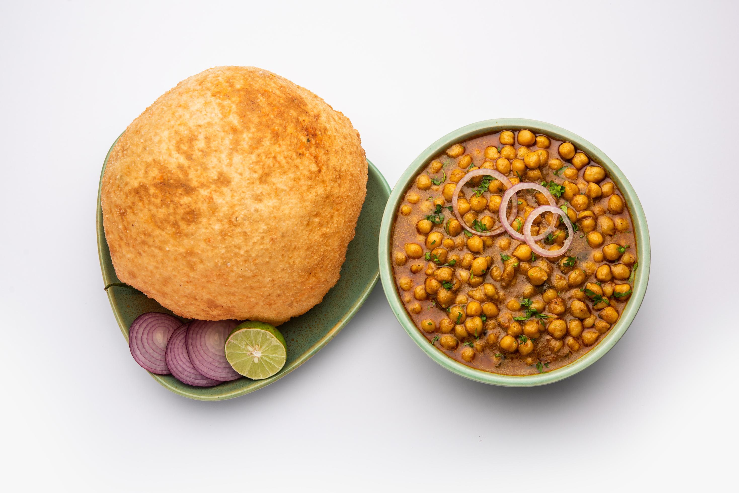 Chole bhature is a North Indian food dish. A combination of chana masala and bhatura or puri Stock Free