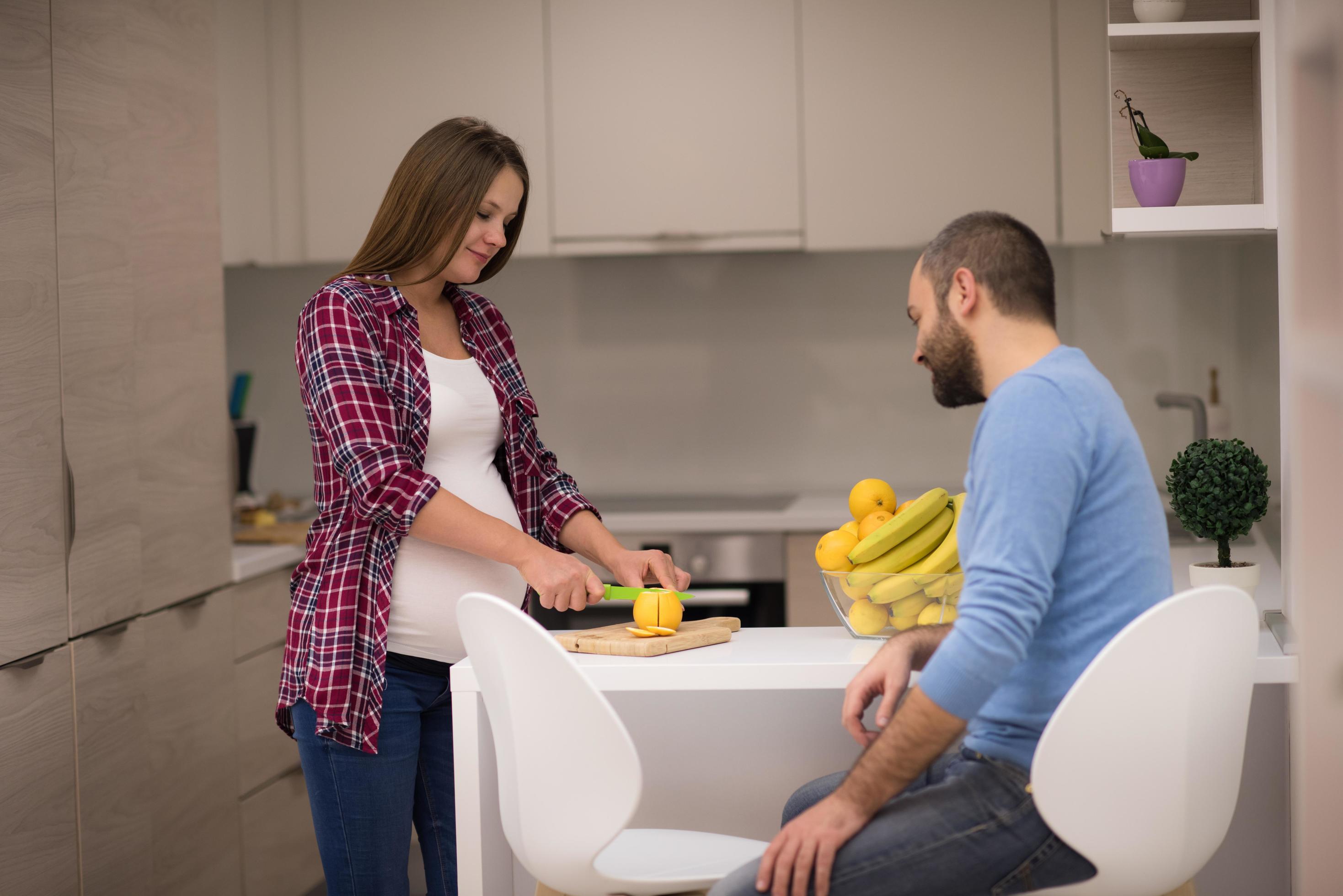 couple cooking food fruit lemon juice at kitchen Stock Free