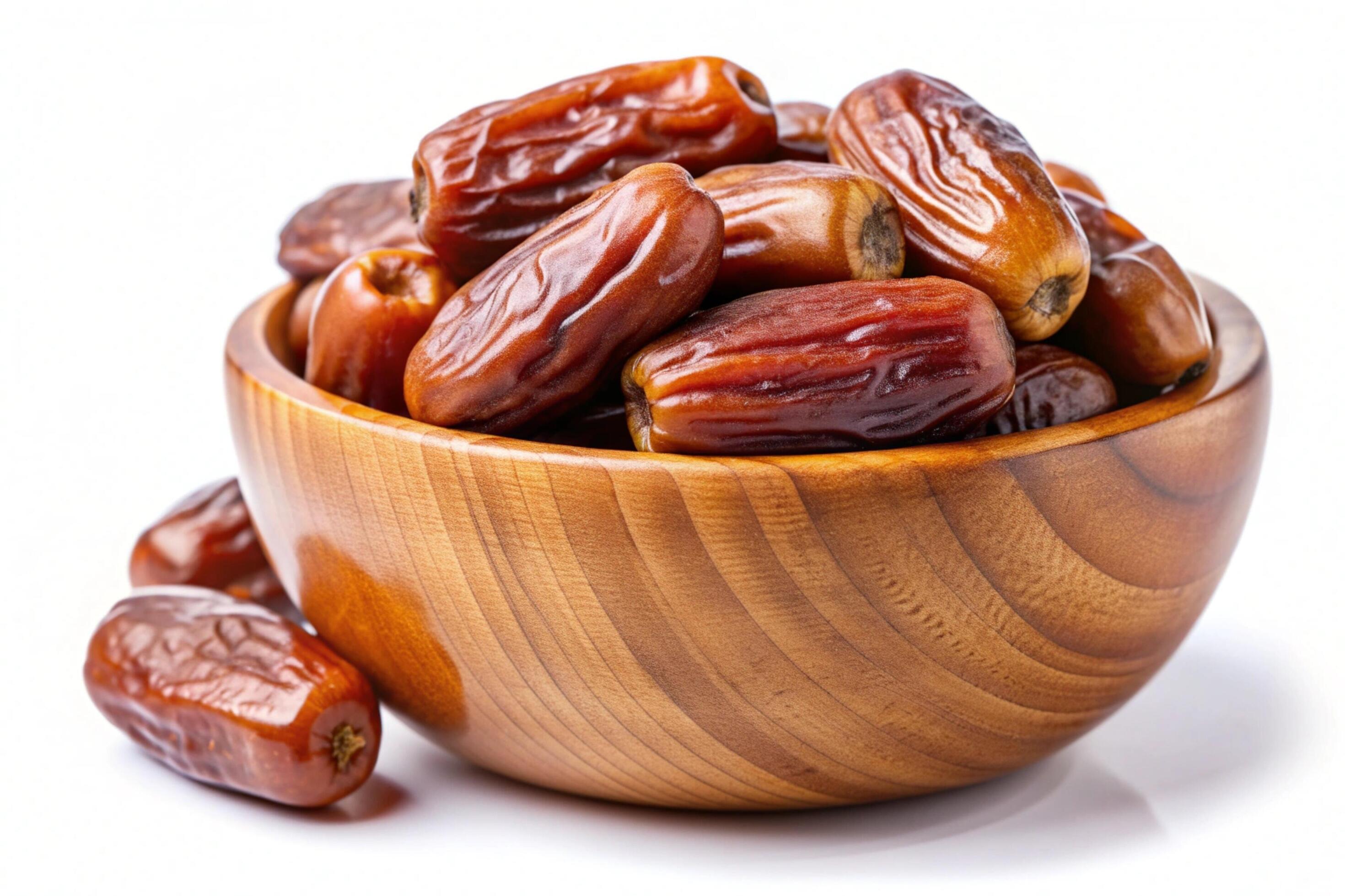 Dates in wood bowl isolated on white background Stock Free