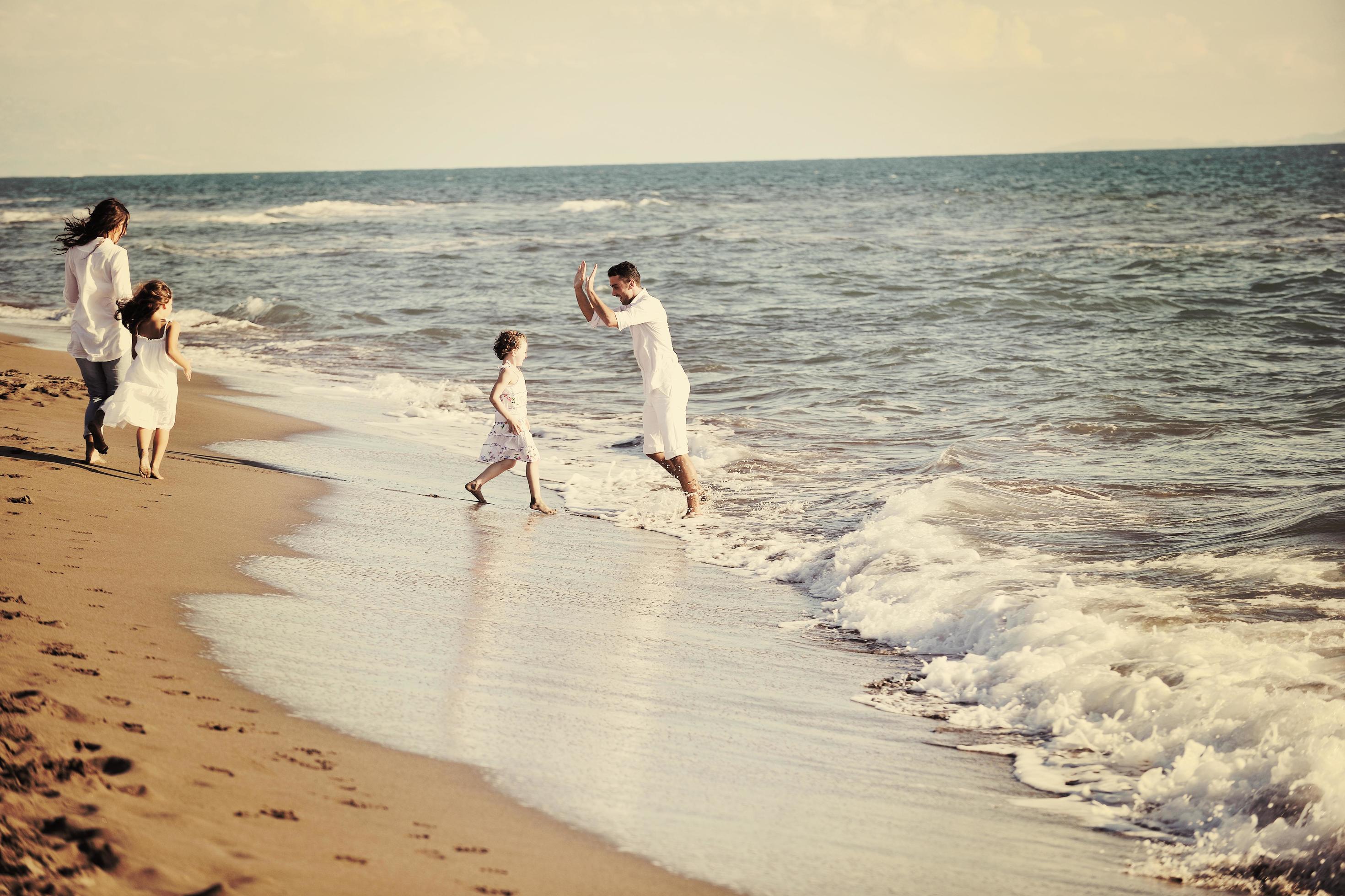 happy young family have fun on beach Stock Free