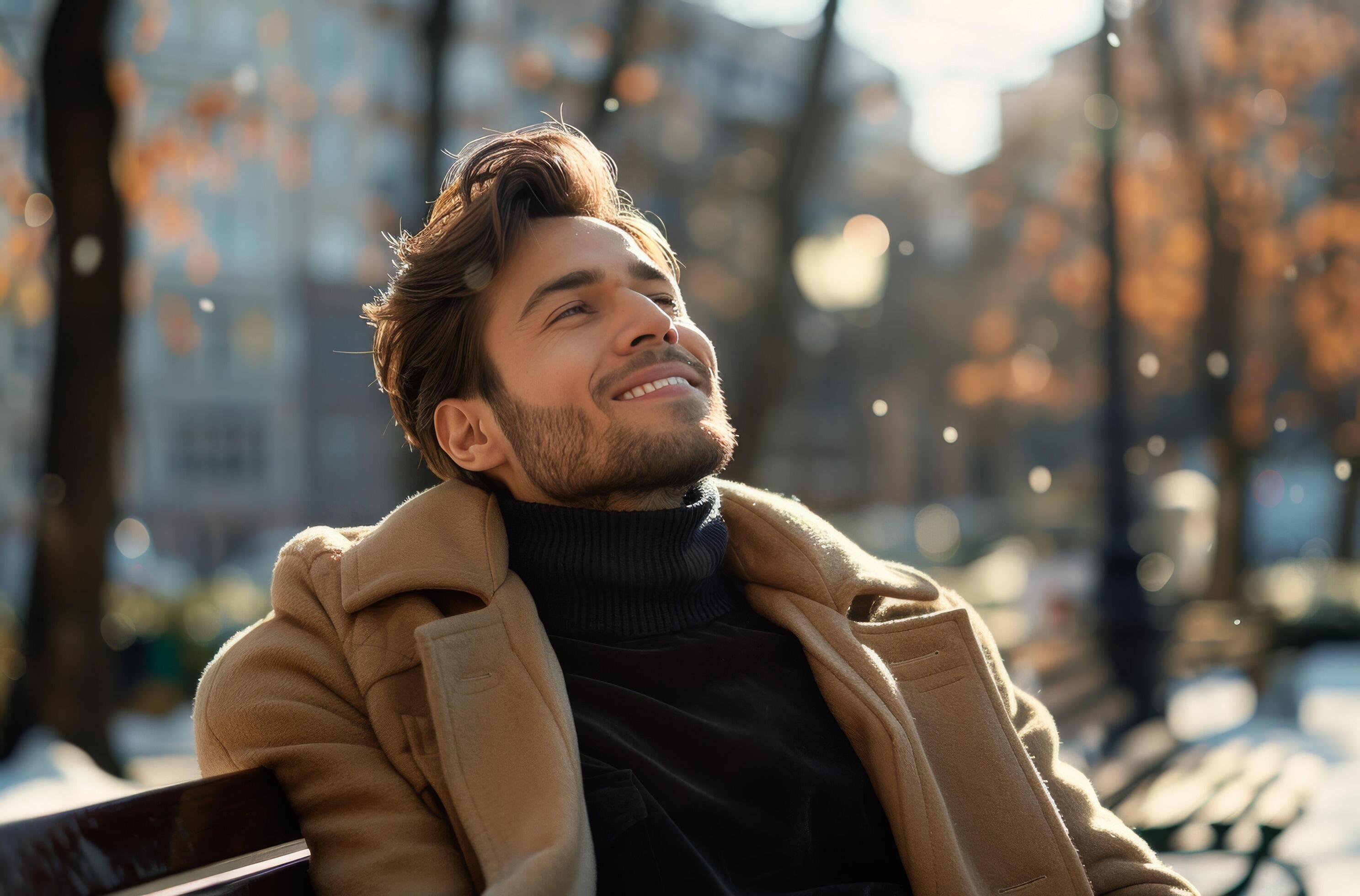 Man Wearing a Brown Coat Sitting on a Bench in the Sunlight Stock Free