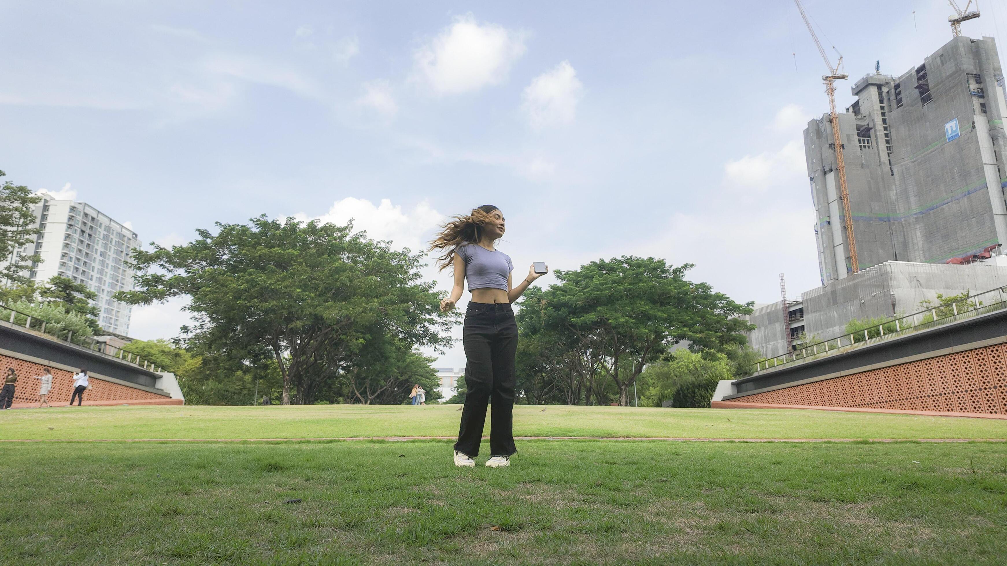 Asian women do freestyle hip hop and breakdancing in a public space in the middle of the city. With a cheerful and happy attitude Stock Free