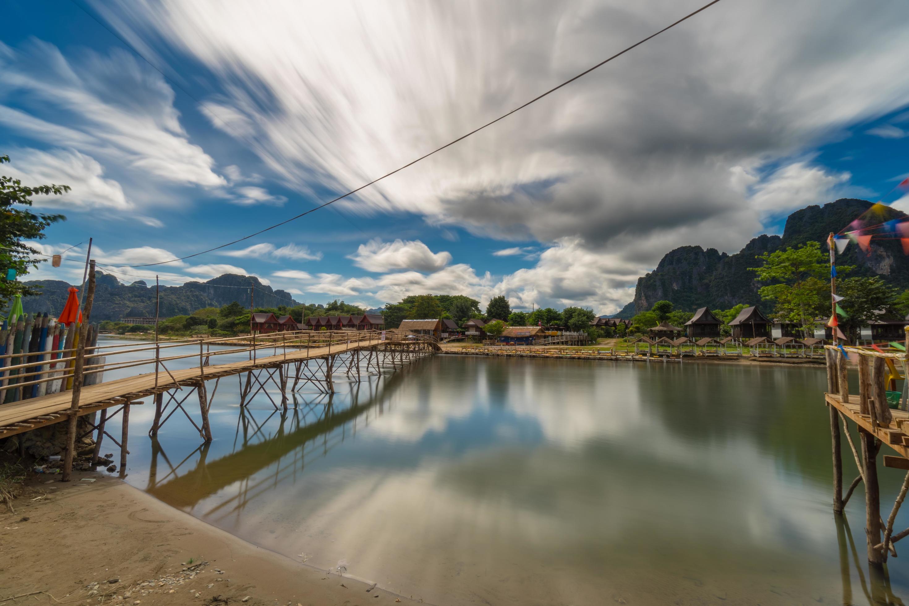 Long exposure Wood bridge on naw song river in Vang vieng, Laos. Stock Free