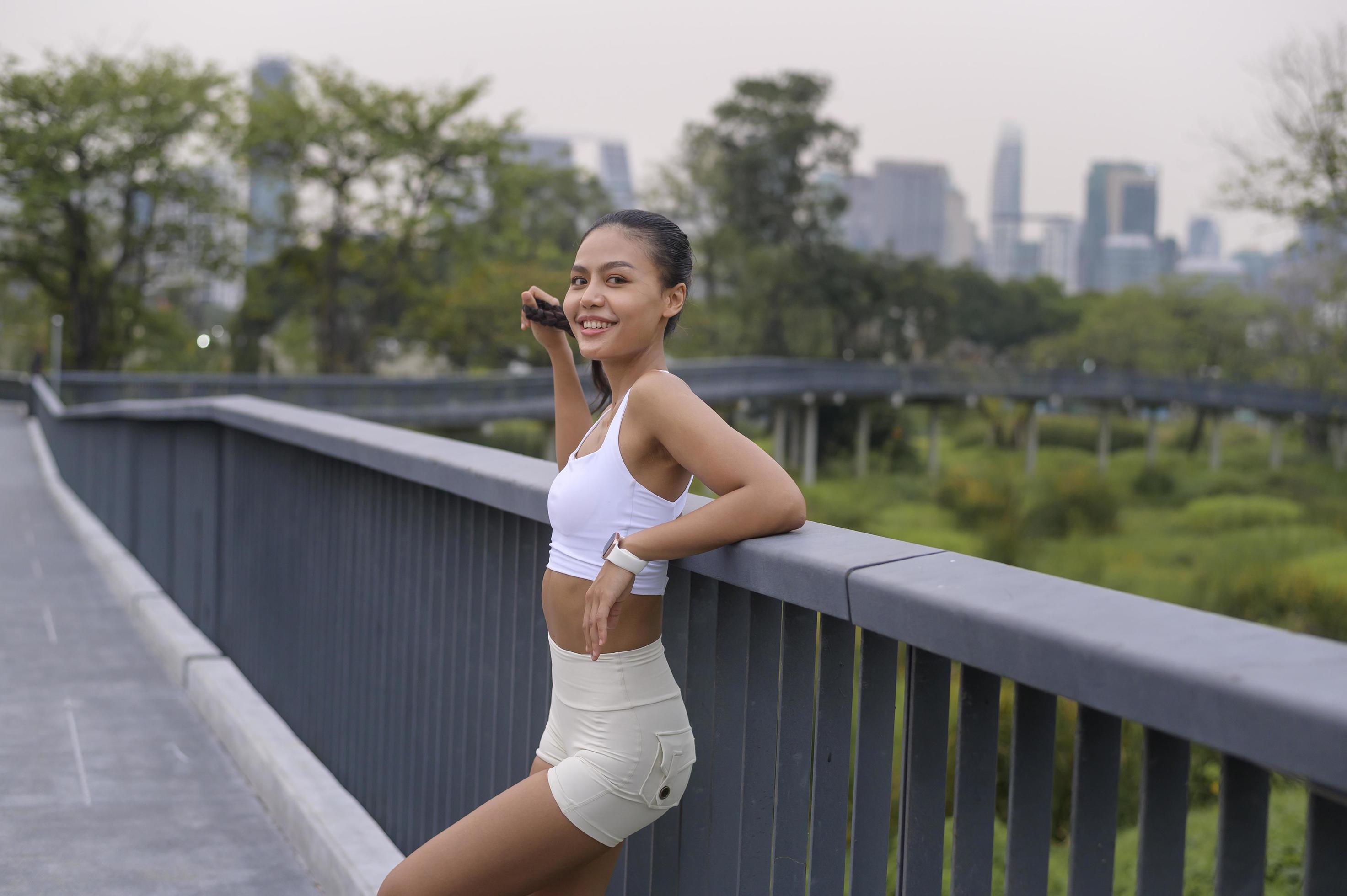 Portrait of young fitness woman in sportswear in city park, Healthy and Lifestyles. Stock Free