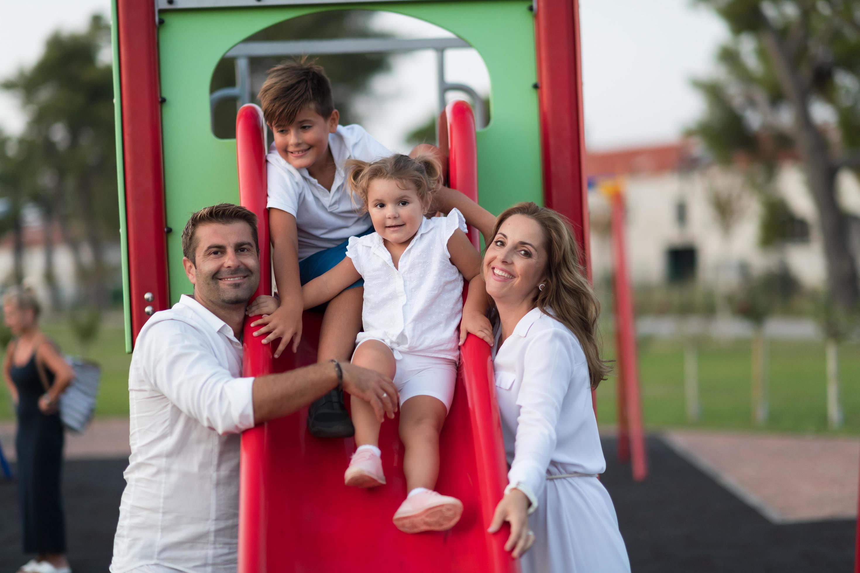 Senior couple in casual clothes with their children spending time in park a vacation together. Family time . Selective focus Stock Free