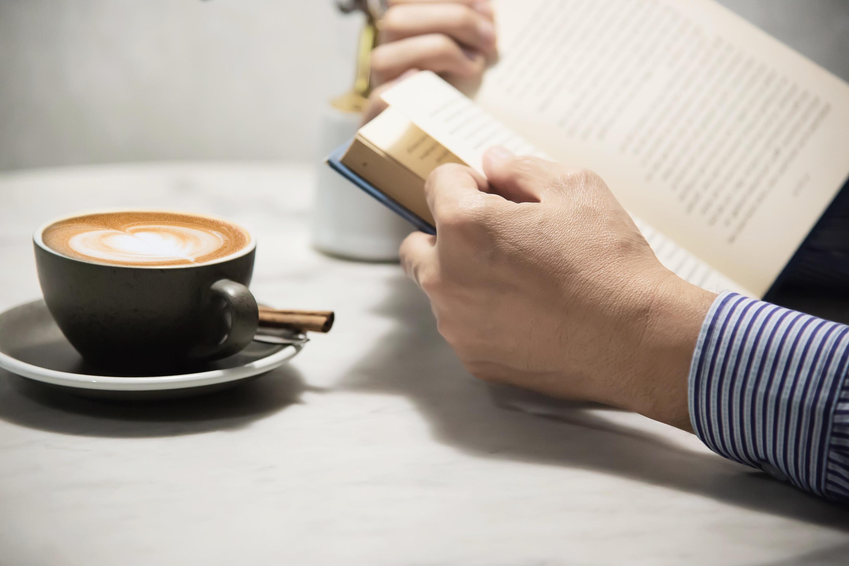 Man read book with beautiful fresh relax morning coffee cup – people relax and coffee lifestyle background concept Stock Free