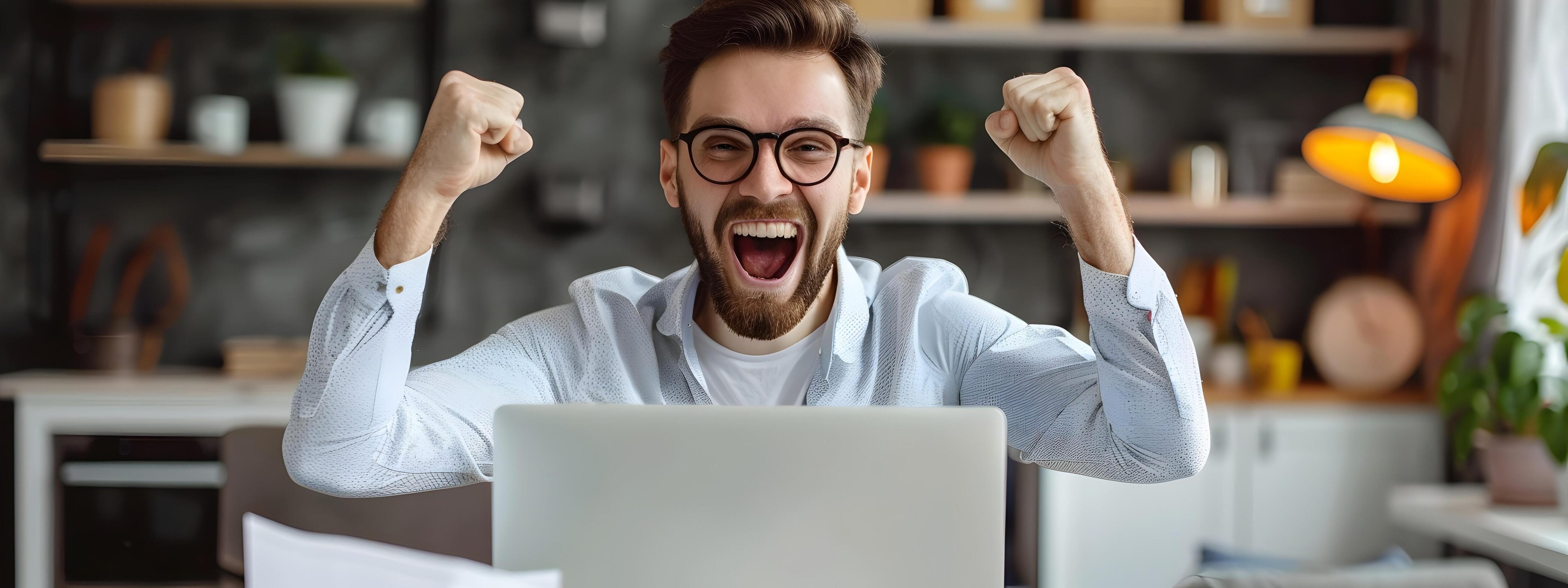 Overjoyed IT Professional Celebrates Successful Workday at Desk Stock Free