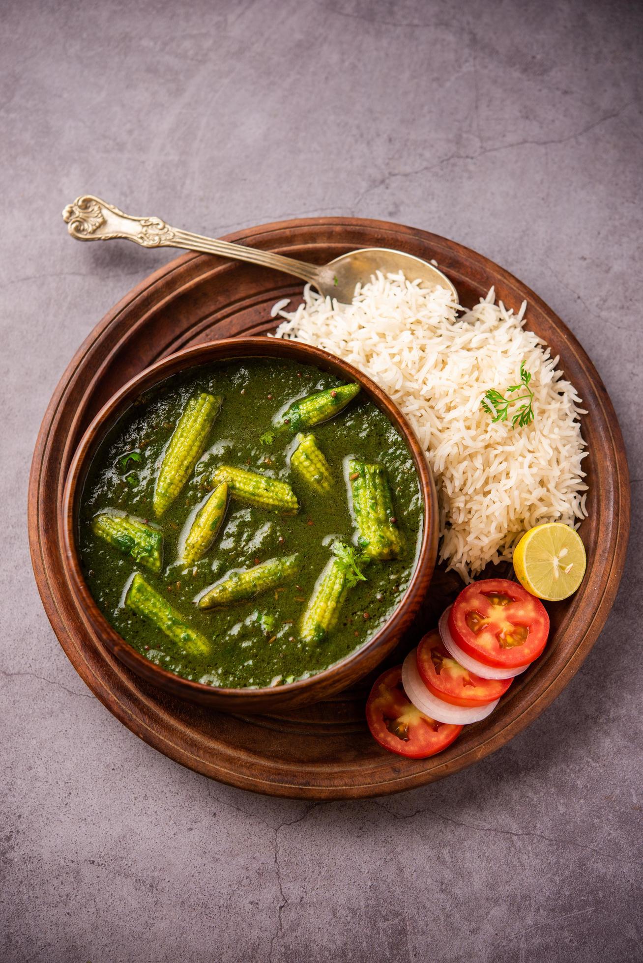 palak baby corn sabzi also known as spinach makai curry served with rice or roti, Indian food Stock Free