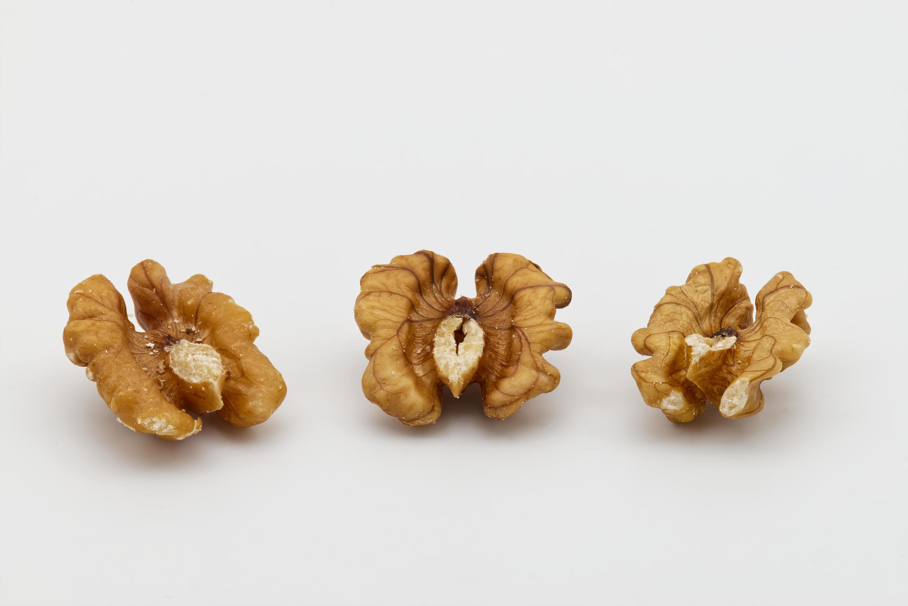 Three walnuts isolated on white background. Food texture concept Stock Free