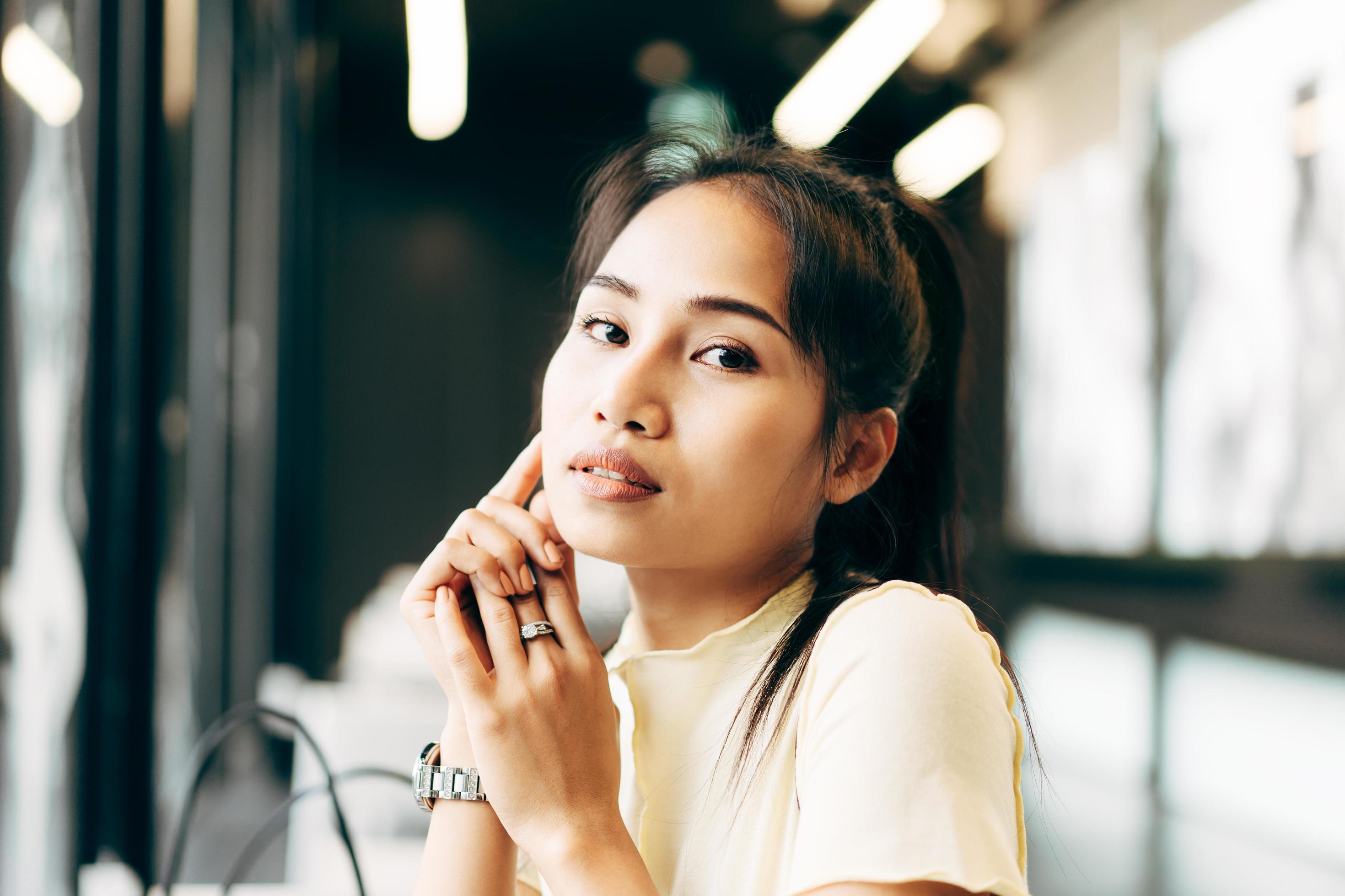 Closeup portrait of young adult asian business woman in office on day Stock Free