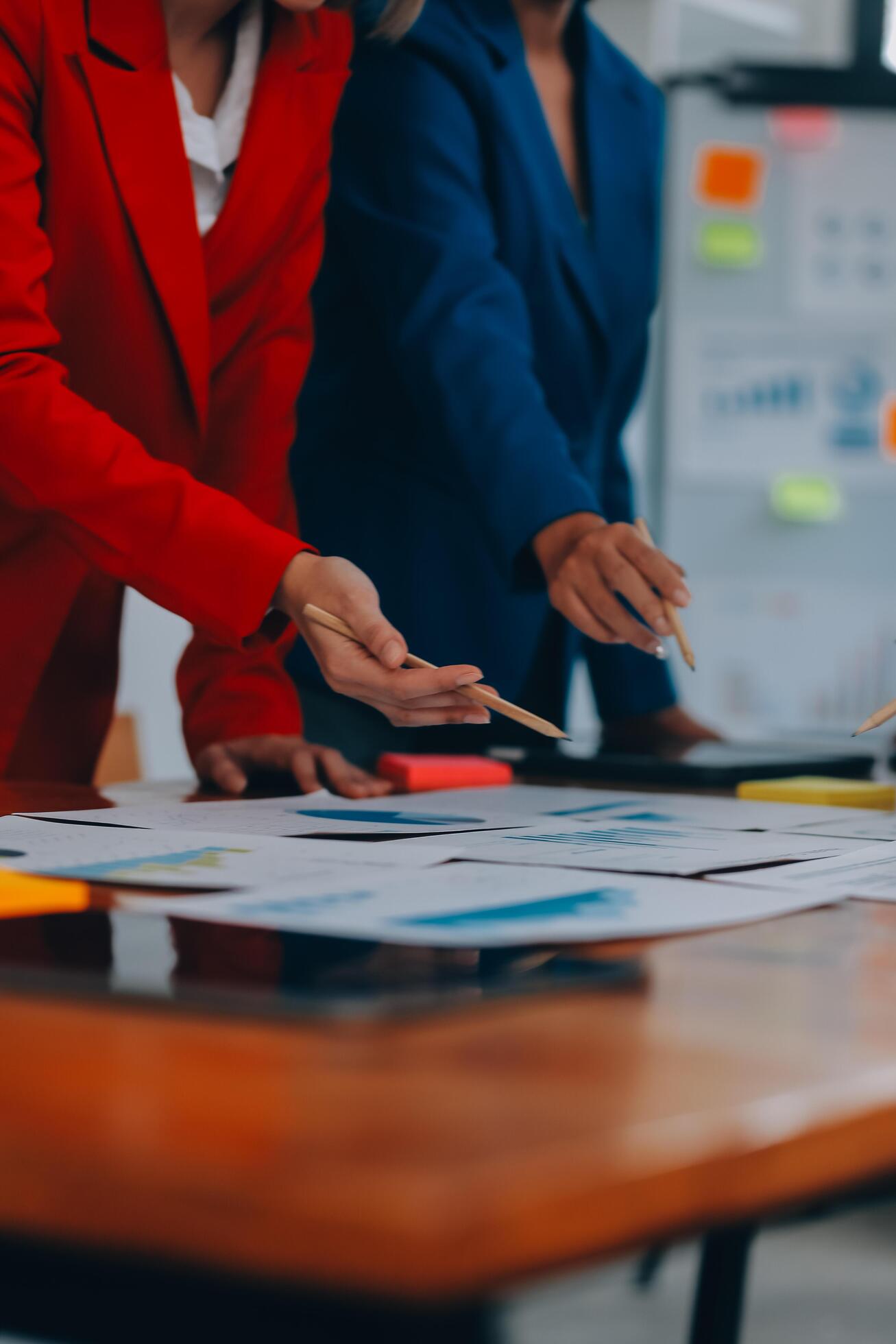 Business professionals. Group of young confident business people analyzing data using computer while spending time in the office Stock Free