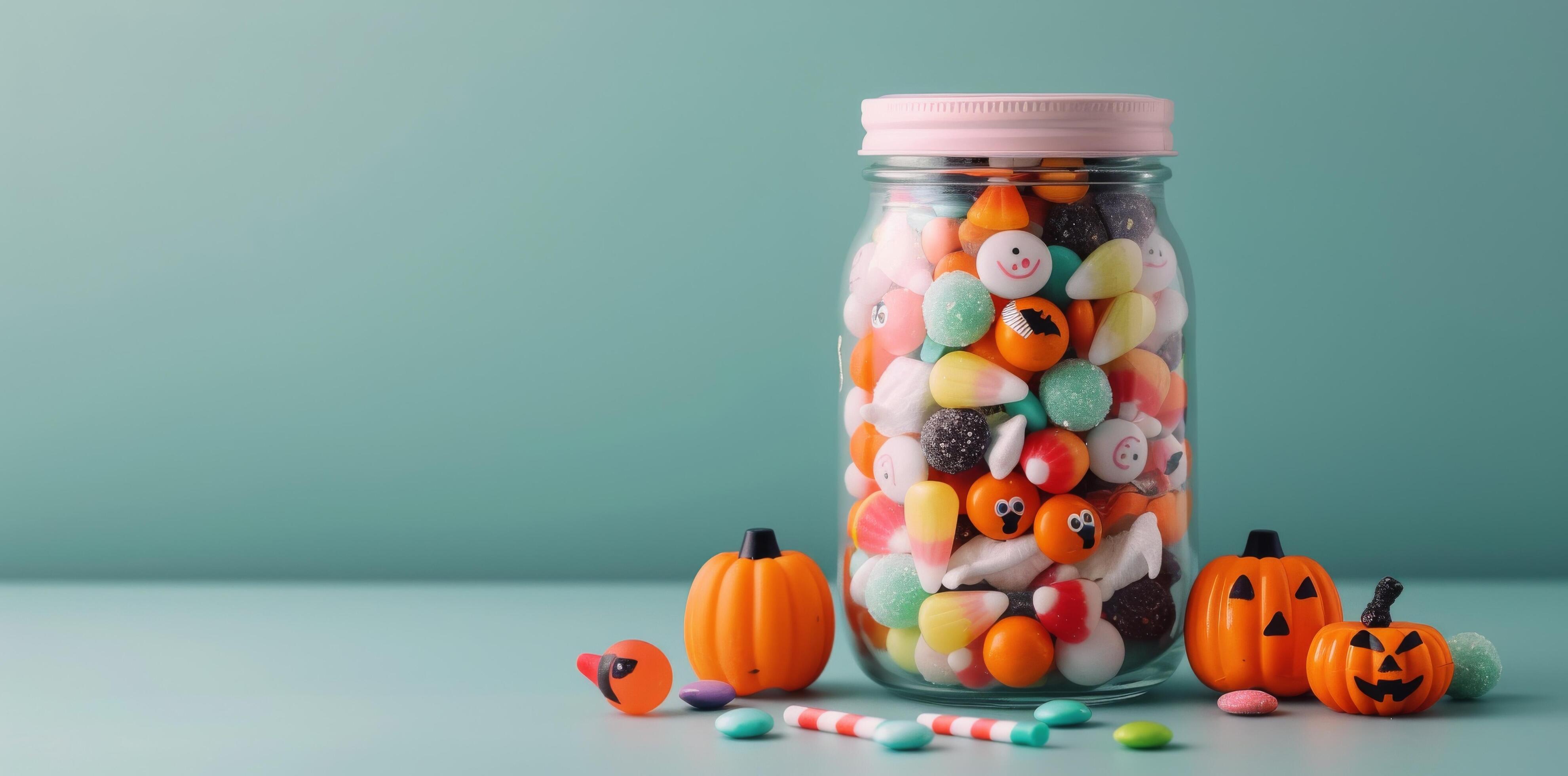 Colorful Candy Jar Filled With Assorted Treats on a Turquoise Background Stock Free