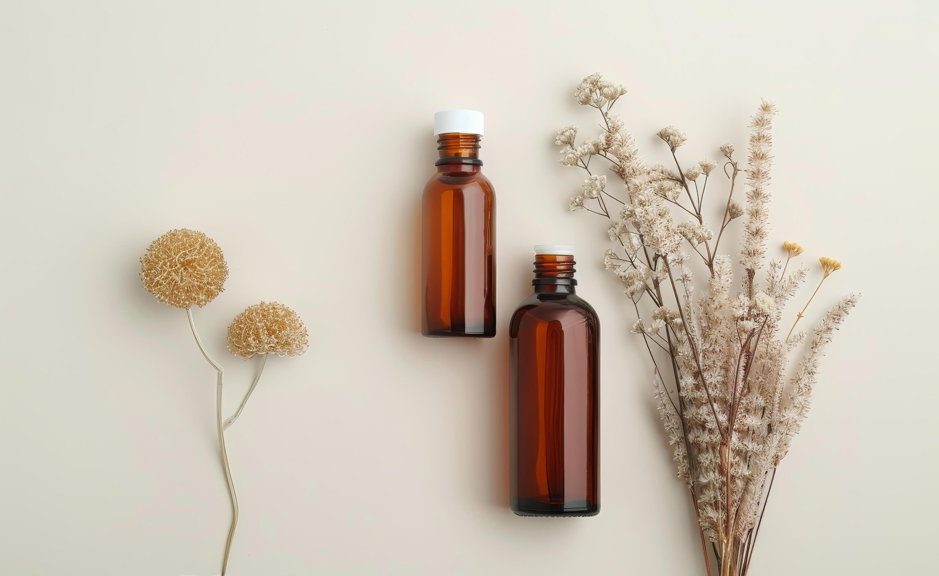 Brown Bottles And Dried Flowers On White Background Stock Free