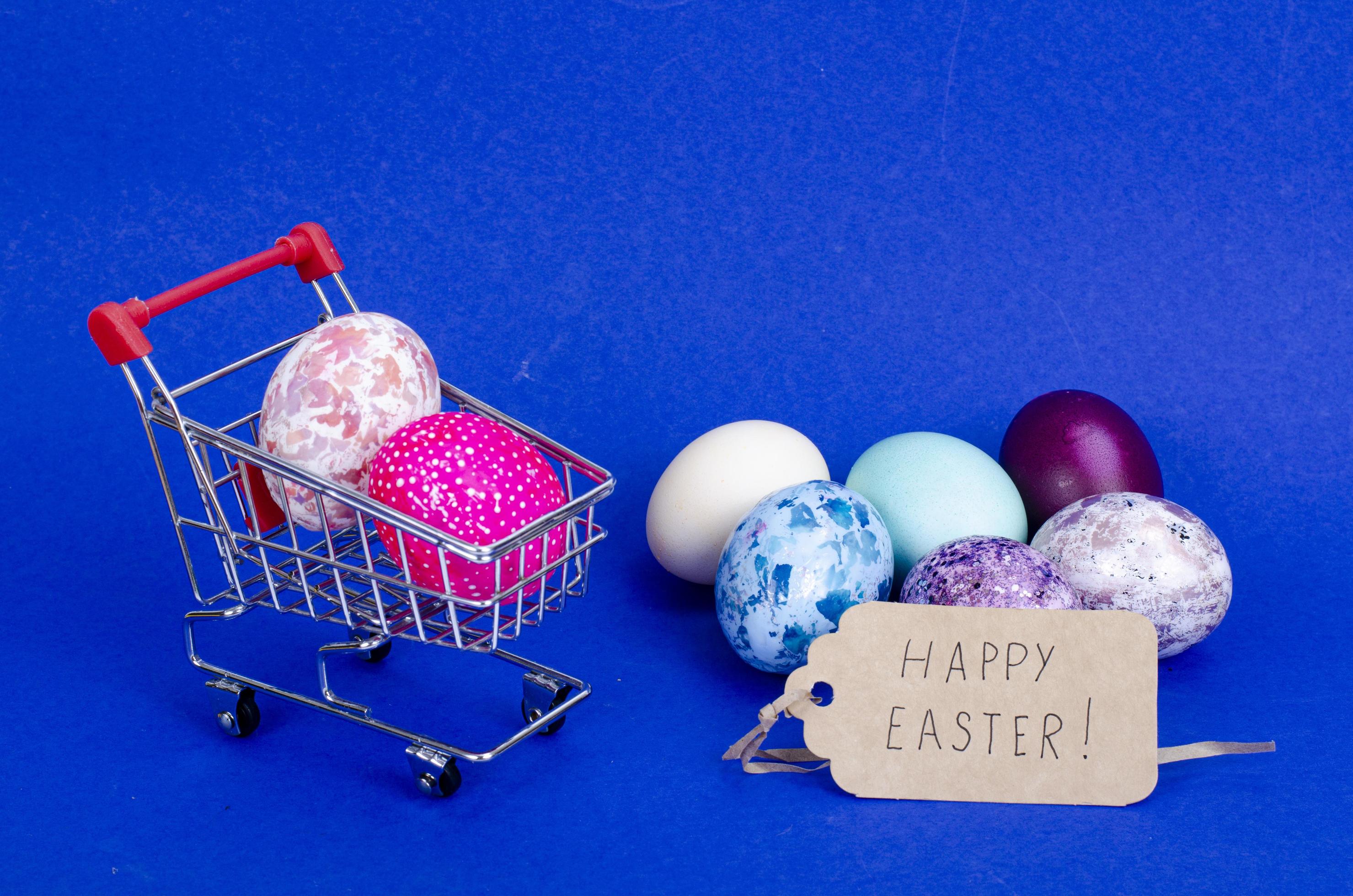 Grocery supermarket cart filled with chicken eggs. Concept of preparing for Easter, buying food. Space for text. Studio Photo Stock Free