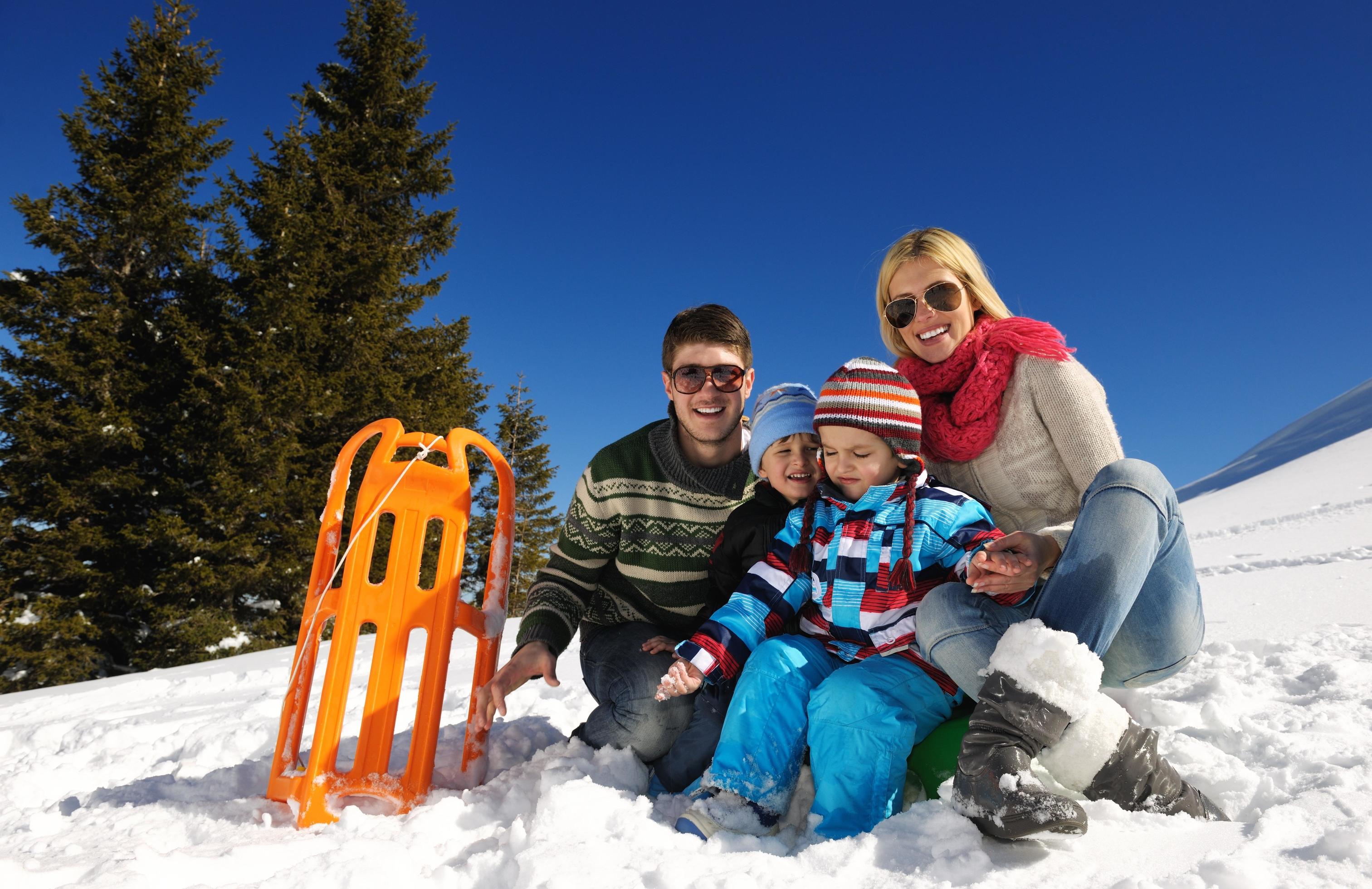 family having fun on fresh snow at winter Stock Free