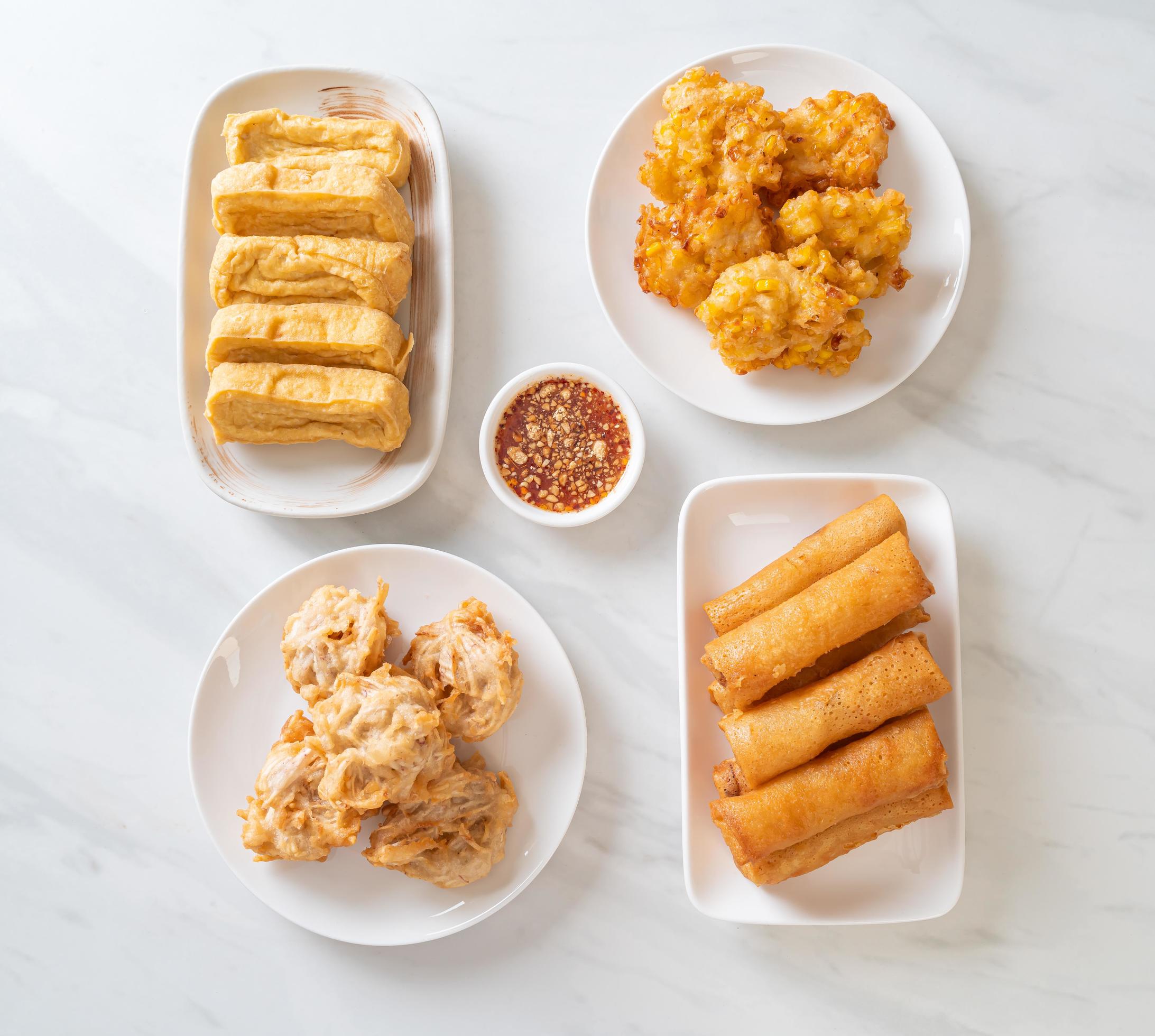 Fried taro, corn, tofu, and spring rolls with sauce – vegan and vegetarian food style Stock Free